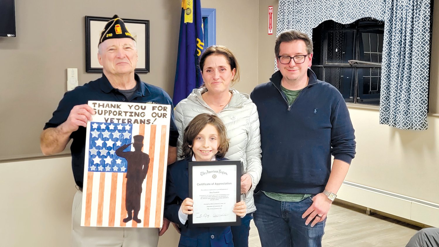 Ben Paoletti, 9, with Peter Scott, commander of Doylestown American Legion Post 210, left, and parents Larisa and Johnathan Paoletti, receives recognition for his efforts on behalf of veterans.