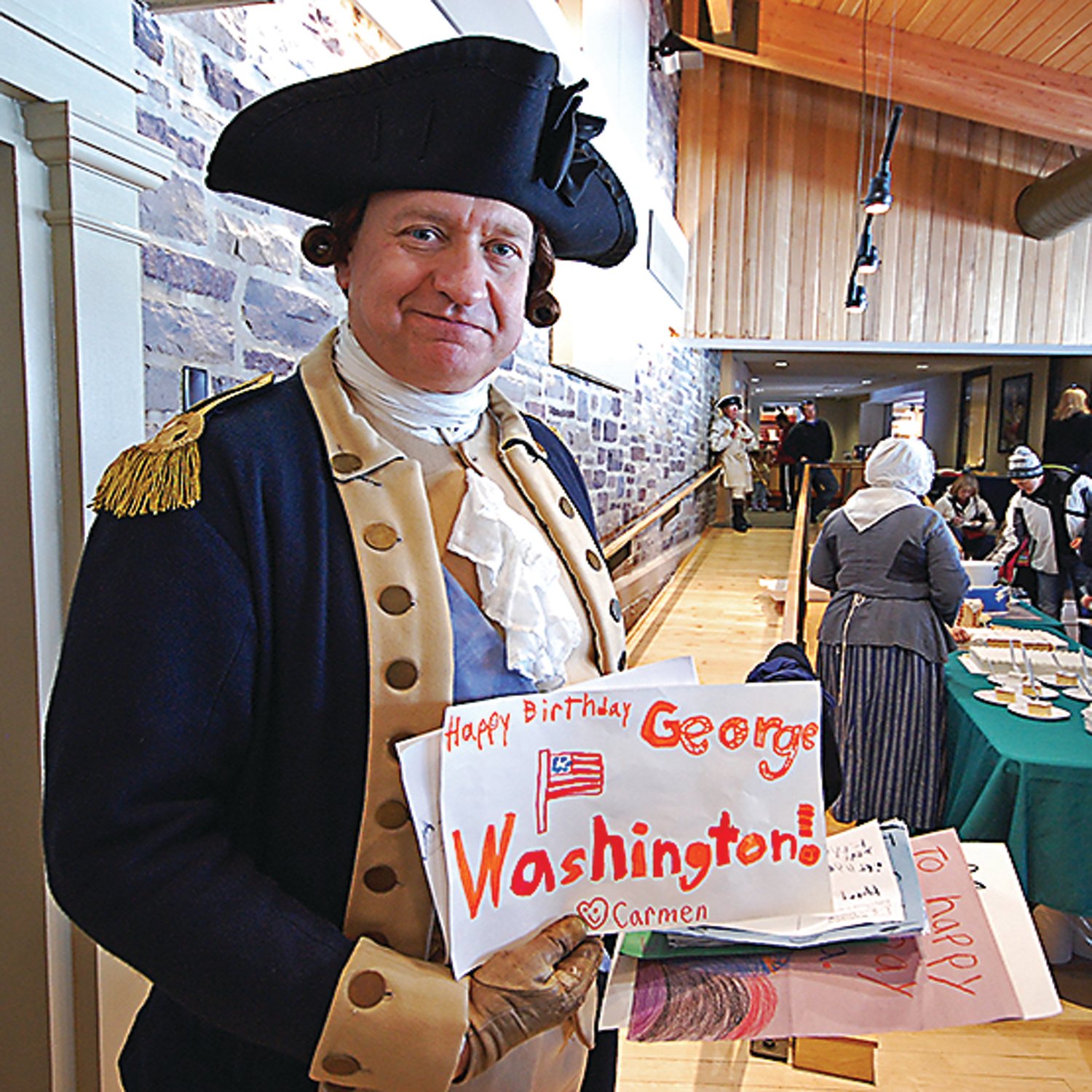 “George Washington” holds handmade birthday cards made just for him. Children are once again invited to create birthday cards for the general and bring them to his birthday party. They can also enter the “Let’s Draw George” contest.