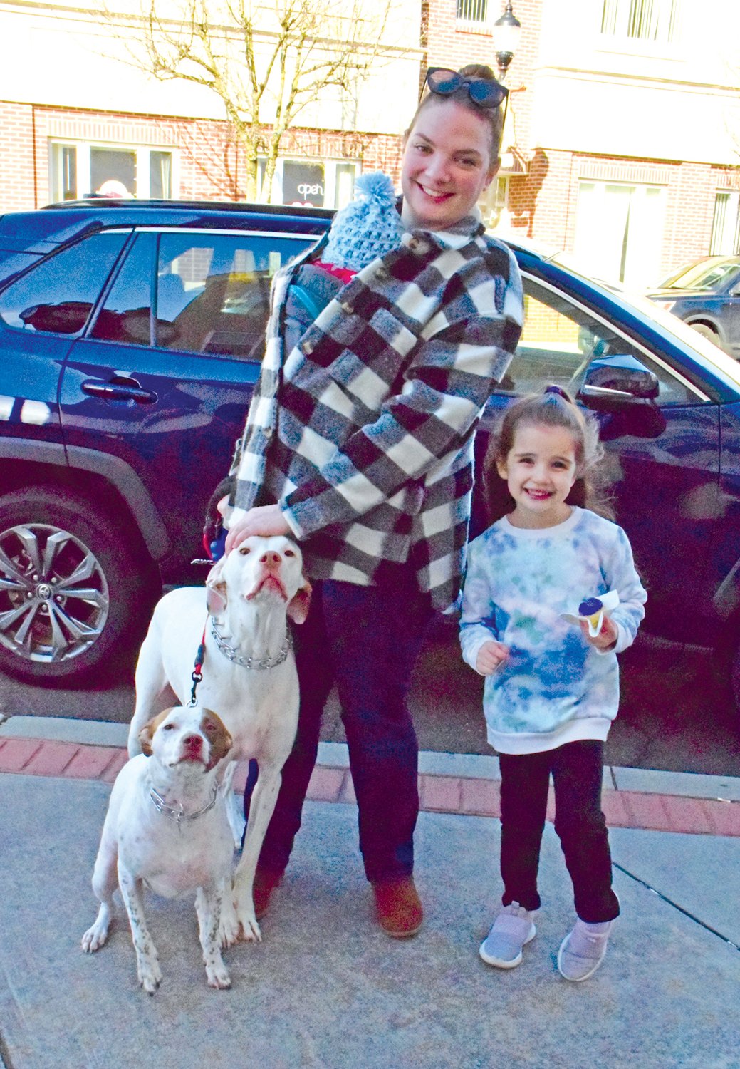 Enjoying the day's festivities on Jan. 28 in downtown Perkasie was Jordan Valente with Lydia and Anna as they walked their dogs Toby and Daisy.