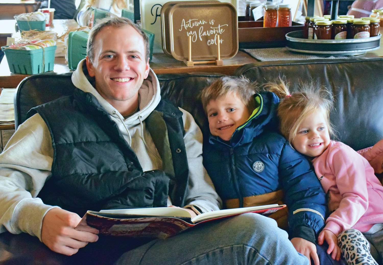 Mike Wodzisz with his children, Cana and Lane, read in a library at Perkasie Rise & Grind during the 'Winter Wanderland' celebration in on Jan. 28.
