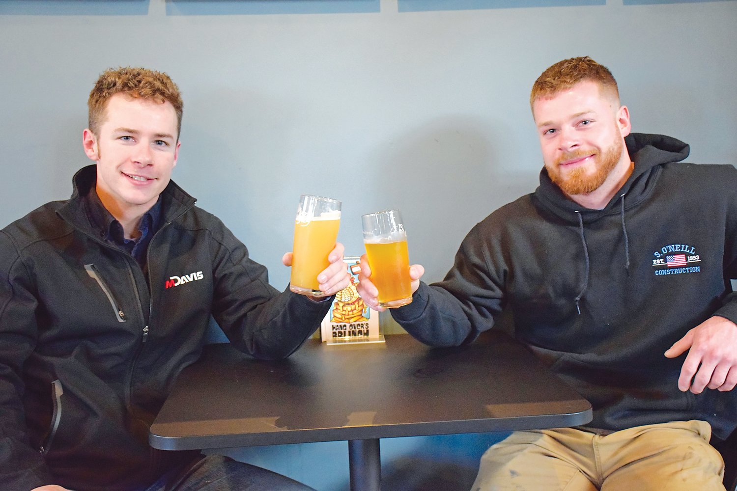 Brothers Lan and Spencer Schultz, of Perkasie, raise a glass in downtown Perkasie on Jan. 28.