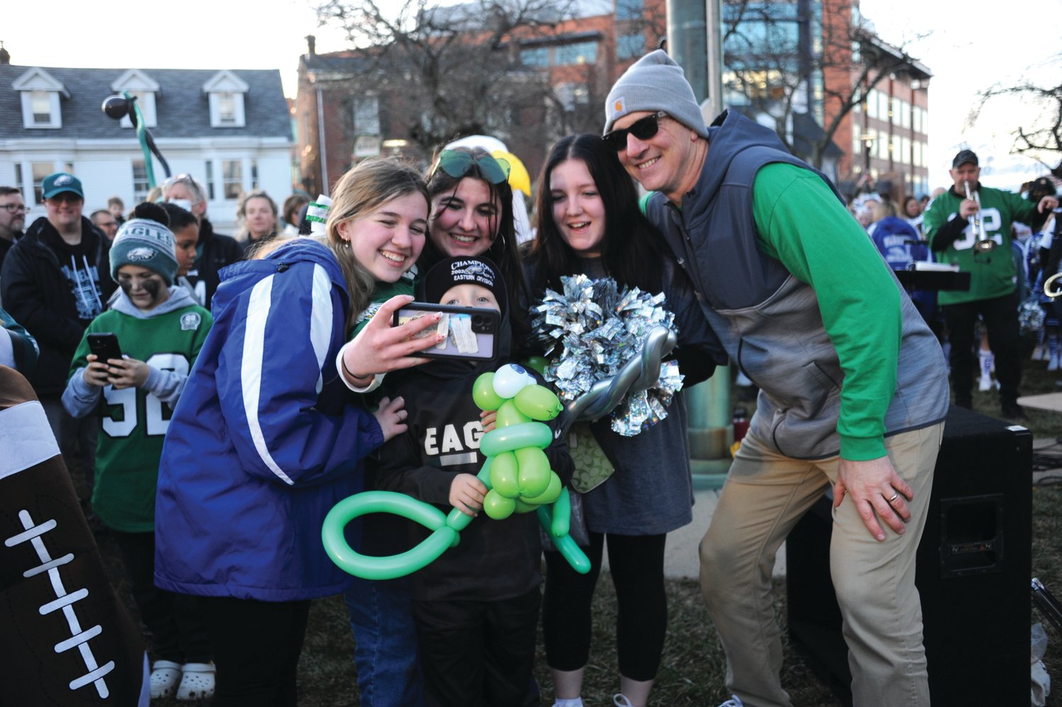 Central Bucks East head football coach John Donnelly, right, poses for a selfie with Eagles fans during Friday’s pep rally in Doylestown.