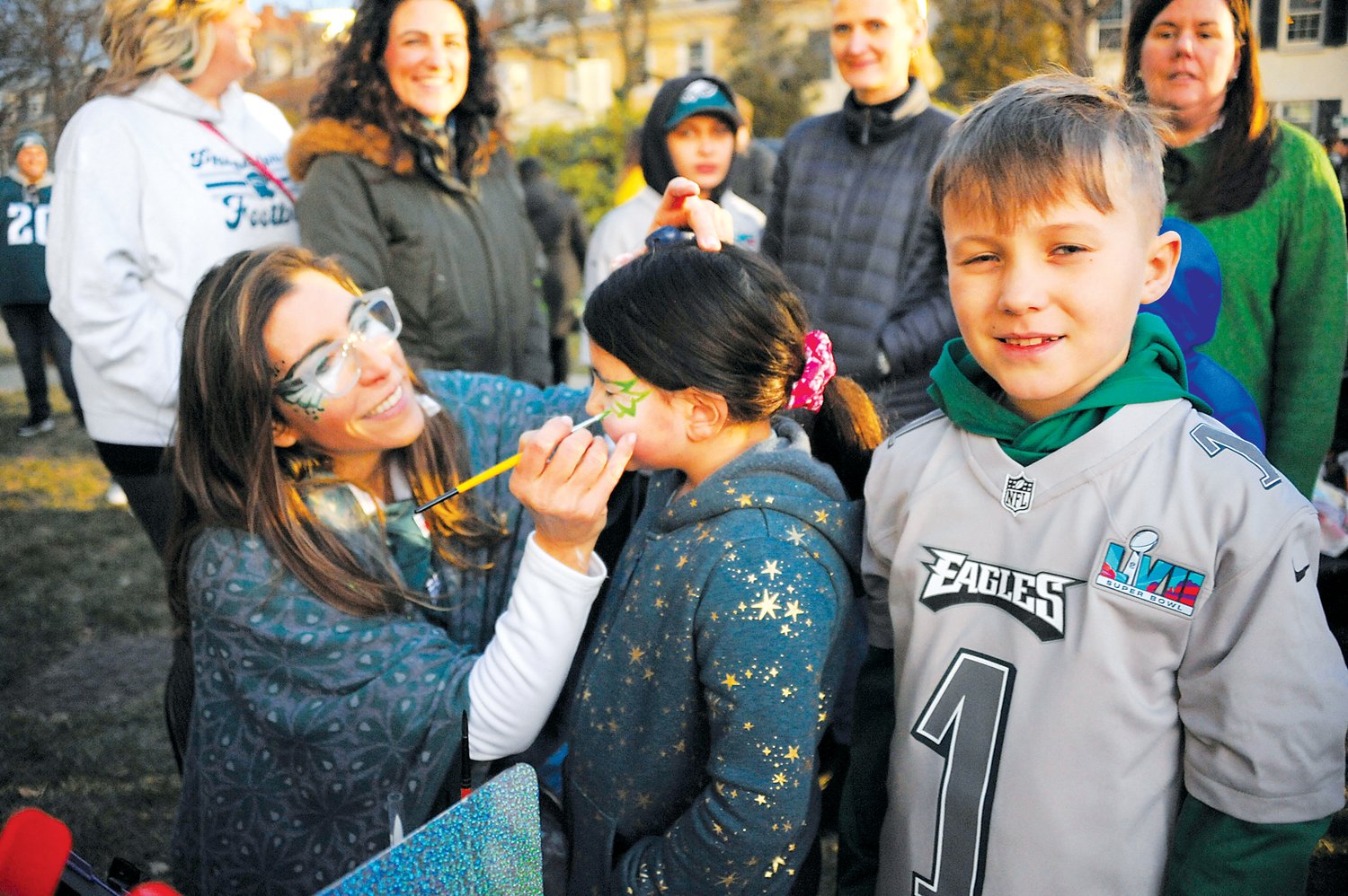 Julie Druzak, of Once Upon A Dream Princess Parties, paints the face of a young Eagles fan at the Herald’s “Bucks County Loves the Birds” pep rally on the lawn of the old county courthouse in Doylestown.