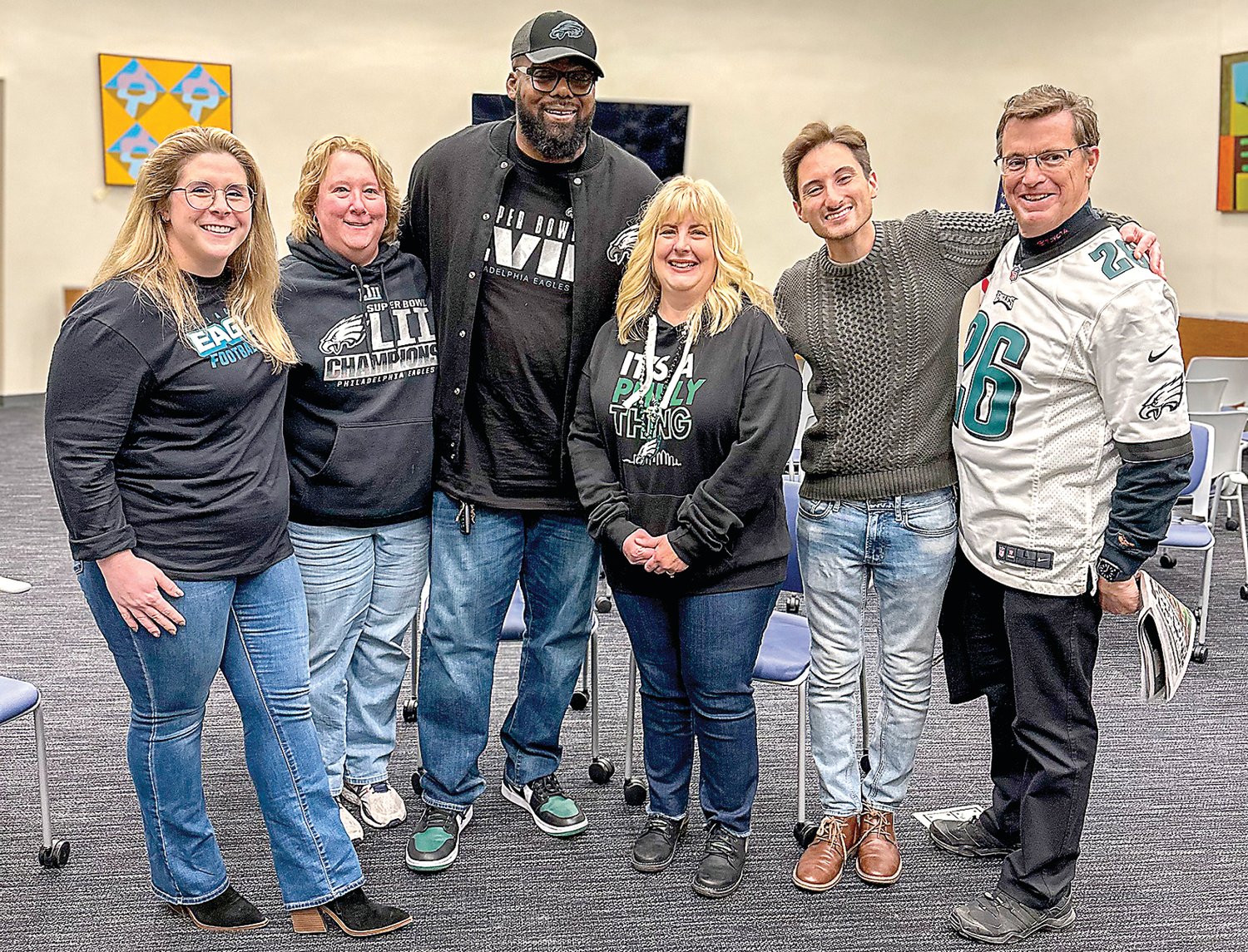 Team members from The Thompson Group, one of the pep rally’s lead sponsors, pose with former Philadelphia Eagles lineman Tra Thomas. Pictured, from left, are Shelby Shaffer, event and sponsorship/social media coordinator; Alicia Hughes, marketing manager; Thomas; Jennifer May, human resources director; Joe Troiano, video content coordinator; and John Thompson, vice president.
