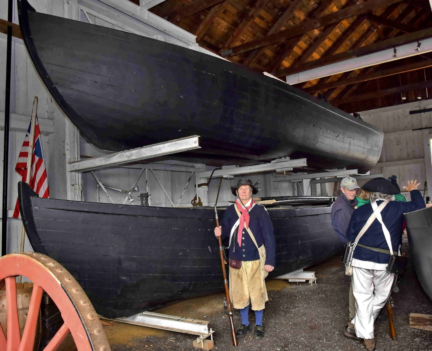 Paul Beck stands next to Durham boats, copies of the original boats used by George Washington to cross the Delaware.