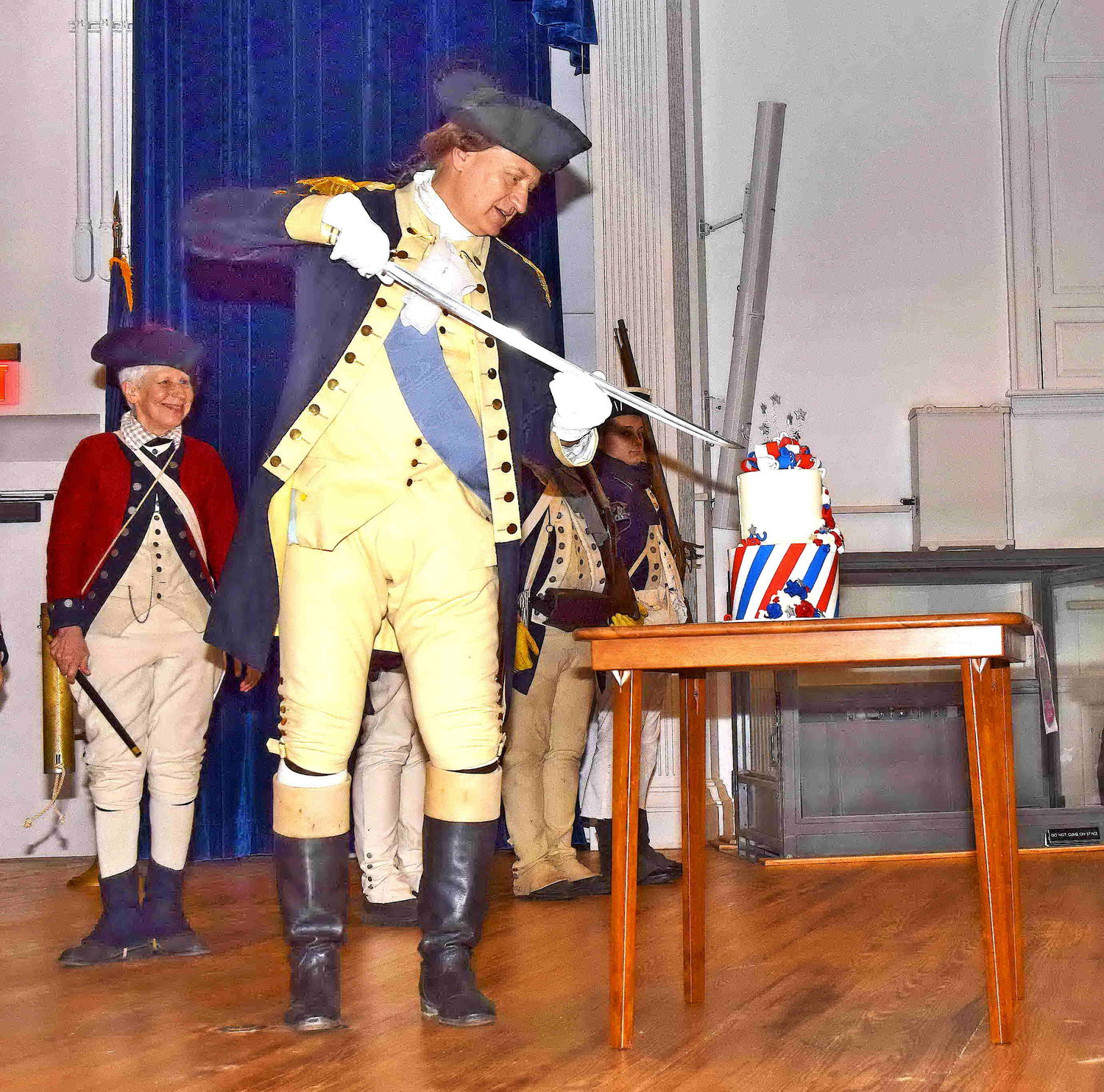 Gen. George Washington, portrayed by John Godzieba, used his sword to cut his birthday cake.
