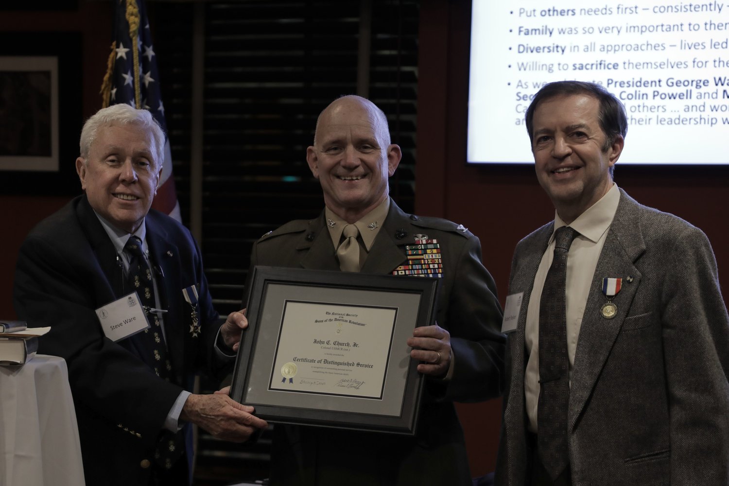 From left: Washington Crossing Chapter Sons of the American Revolution First Vice President Steven Ware, Col. John Church, holding the SAR Distinguished Service Certificate, and chapter President Robert Reiser.