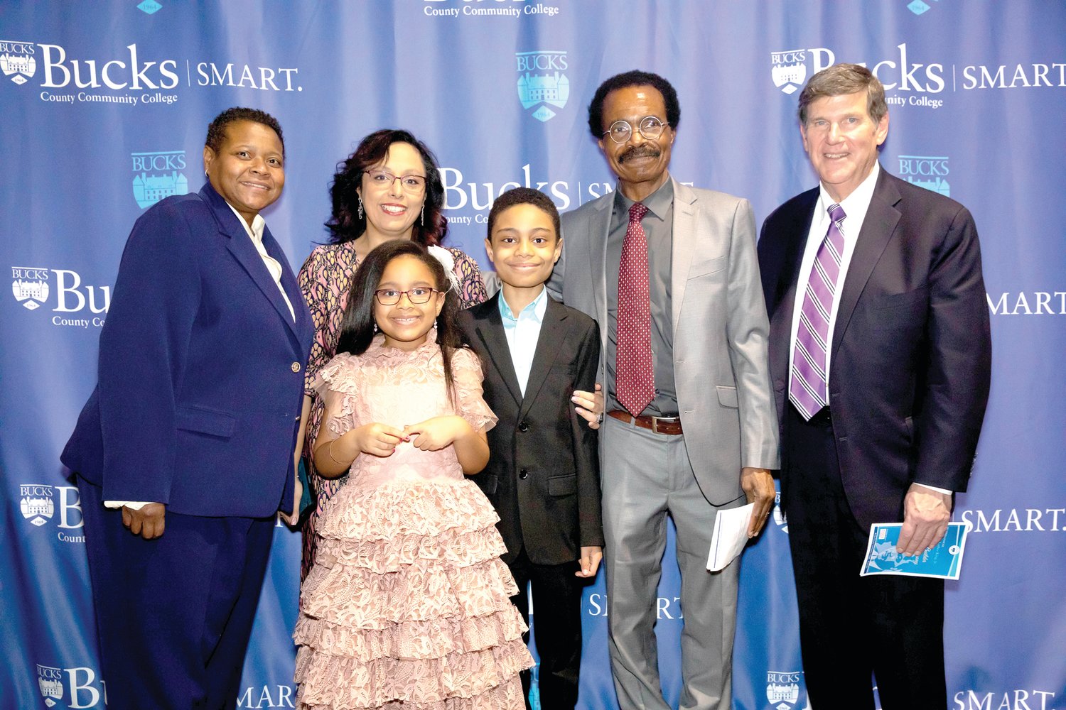 David Balogun, center, a 9-year-old Bensalem resident and Bucks County Community College student, was honored for his accomplishments at the college’s second annual Dr. Martin Luther King Jr. Dream Builders Awards ceremony. He was congratulated by Dr. Felicia Ganther, left, college president, and Tom Jennings, right, chair of the college’s board of trustees, and joined by his mother Ronya Balogun, father Henry Balogun and sister Eliana.