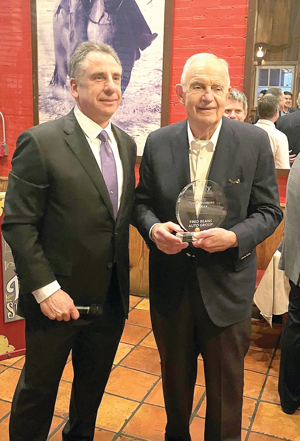 Wayne Pastore, COO and president of distribution for Polly, left, presents the Top Performing Dealer of the Year award to Fred Beans.