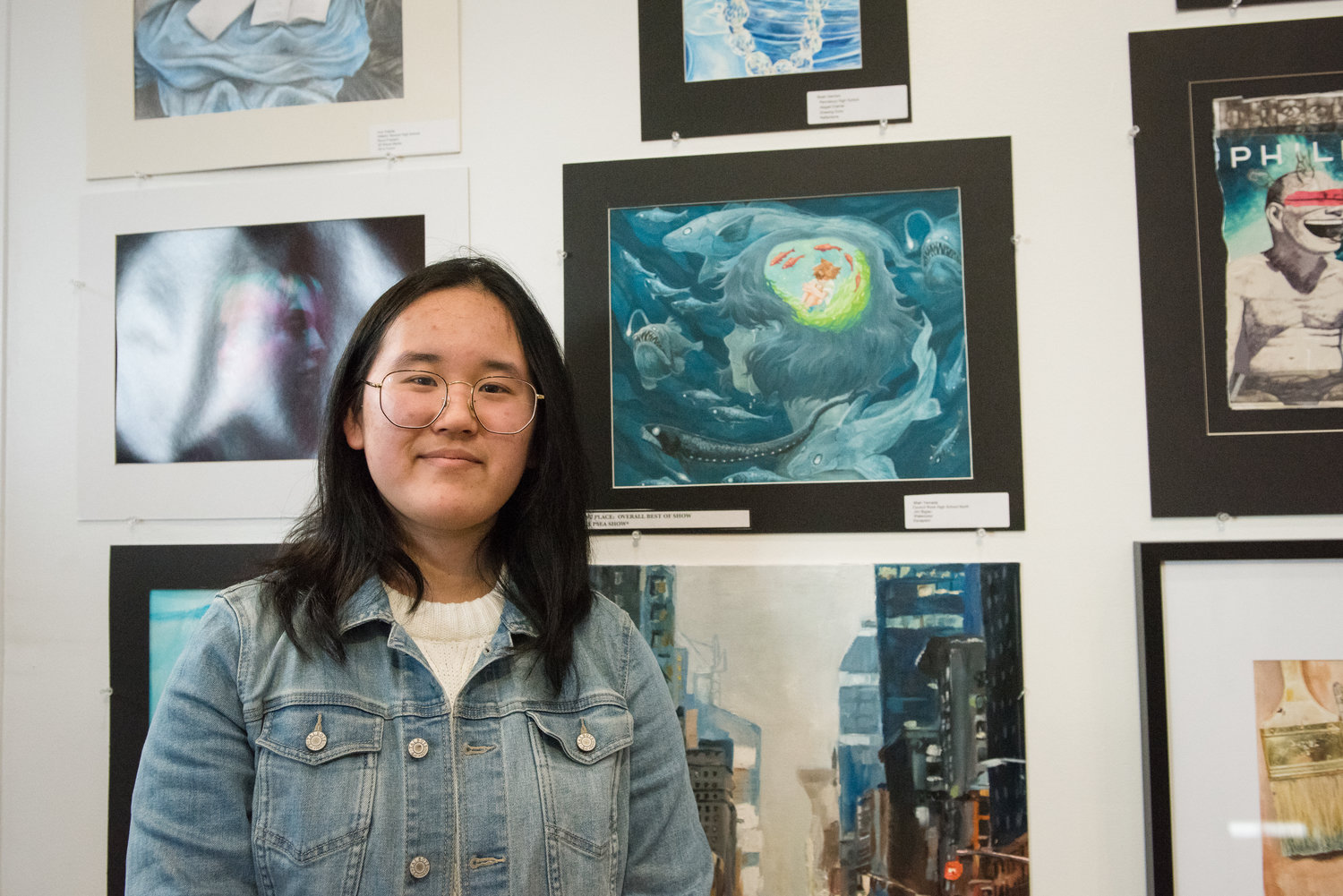 Miah Yamada, of Council Rock High School North, displays her painting “Escapism.” The piece, nominated by her teacher Jim Biglan, took Best in Show honors at the 36th Annual Touch the Future Art Show Sunday at Montgomery County Community College.