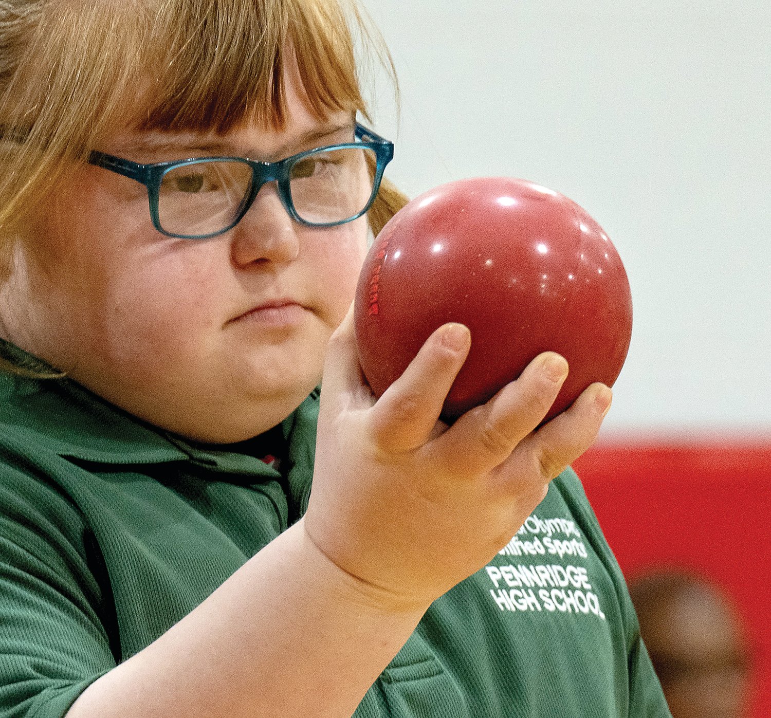 Rylee Wunsch, of Pennridge High School, holds her bocce ball as she sizes up the distance from her end of the bocce ball court to the other end at Bristol High School March 3.