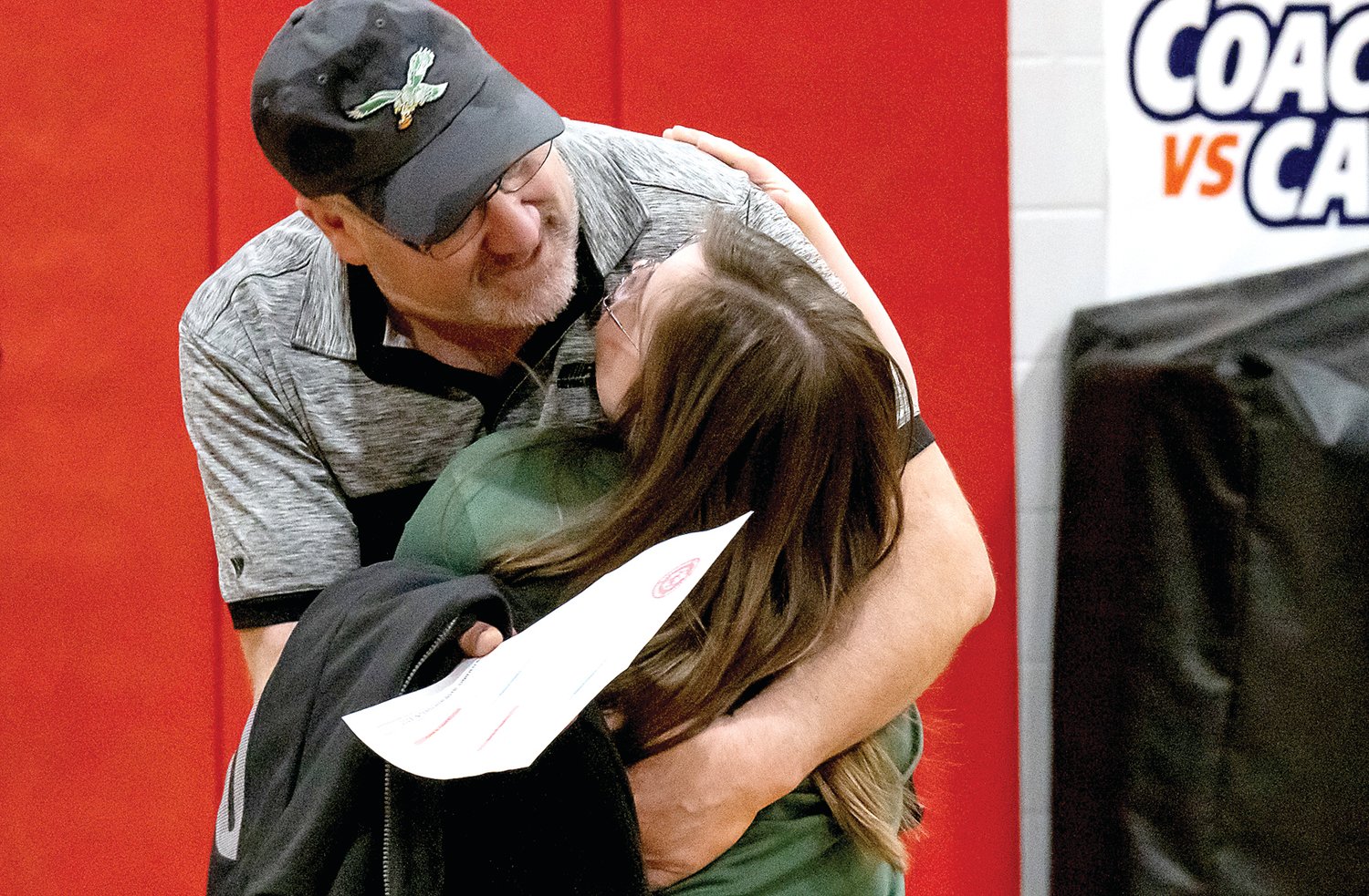 Pennridge high school student Gianna Priole runs to hug her dad, Mark Priole, after their second place victory.