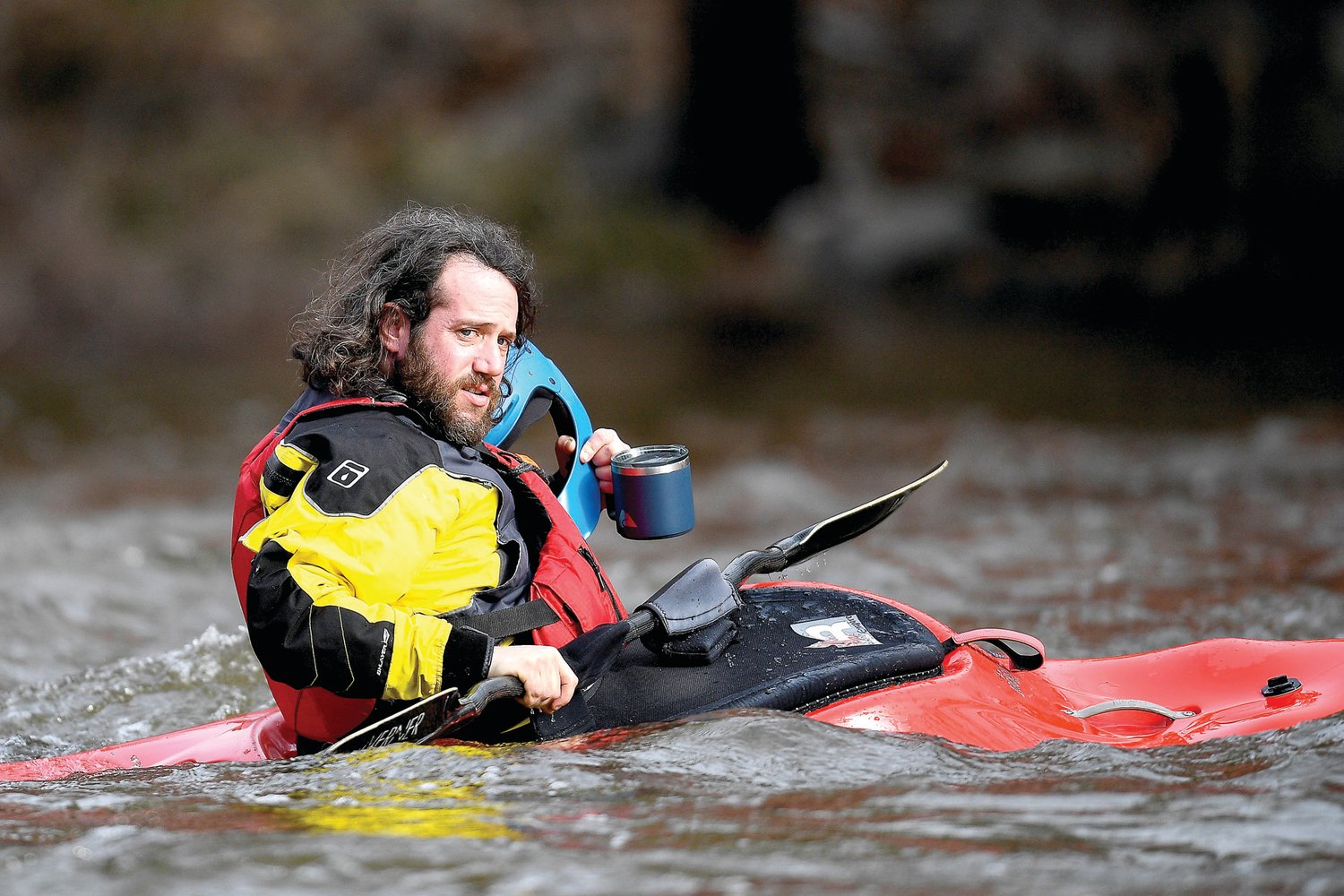A kayaker has one last sip of coffee before heading downstream on March 18.