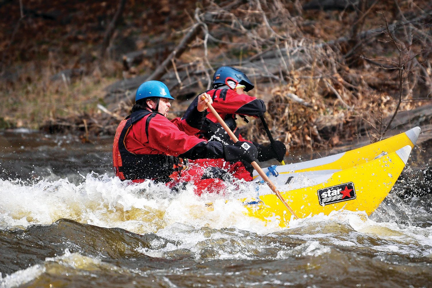 Two rafters on a double hull raft make their way over a white cap on March 18.