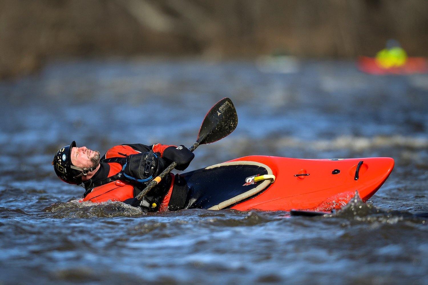 A kayaker gets some sun while out on the water.