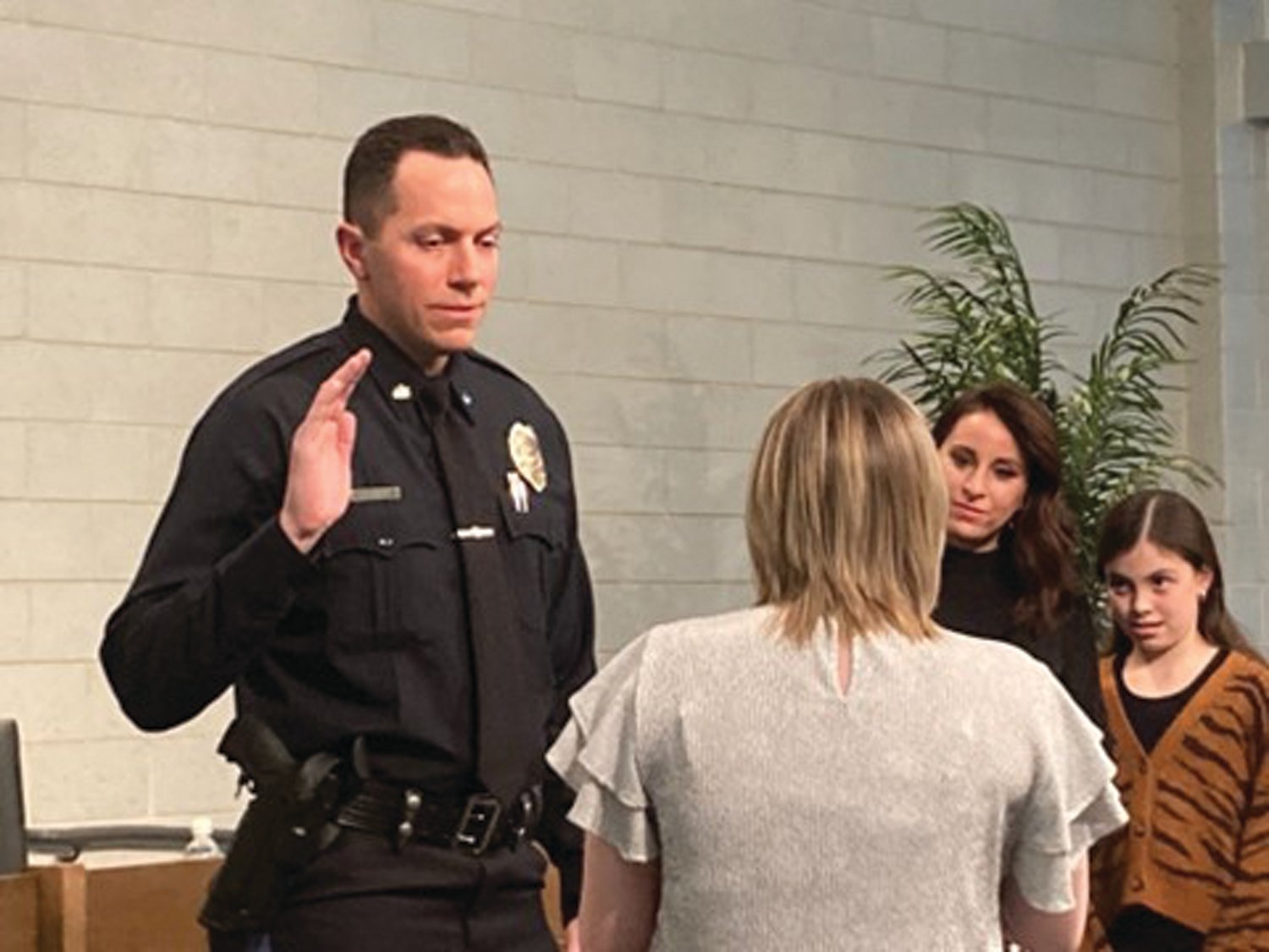 Newest Middletown Police Officer Michael Leonard is sworn in by board of supervisors’ Chairwoman Anna Payne as Leonard’s wife, Katie, left, and one of his daughters, Maggie, look on.