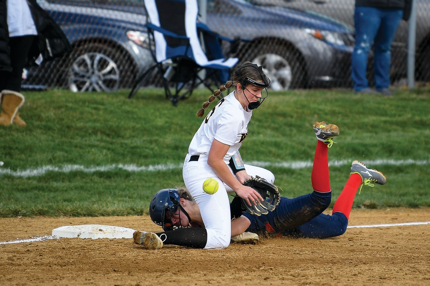 CB East’s Elizabeth Gray slides in safely as CB West’s Julia Thomas tries to handle the throw.