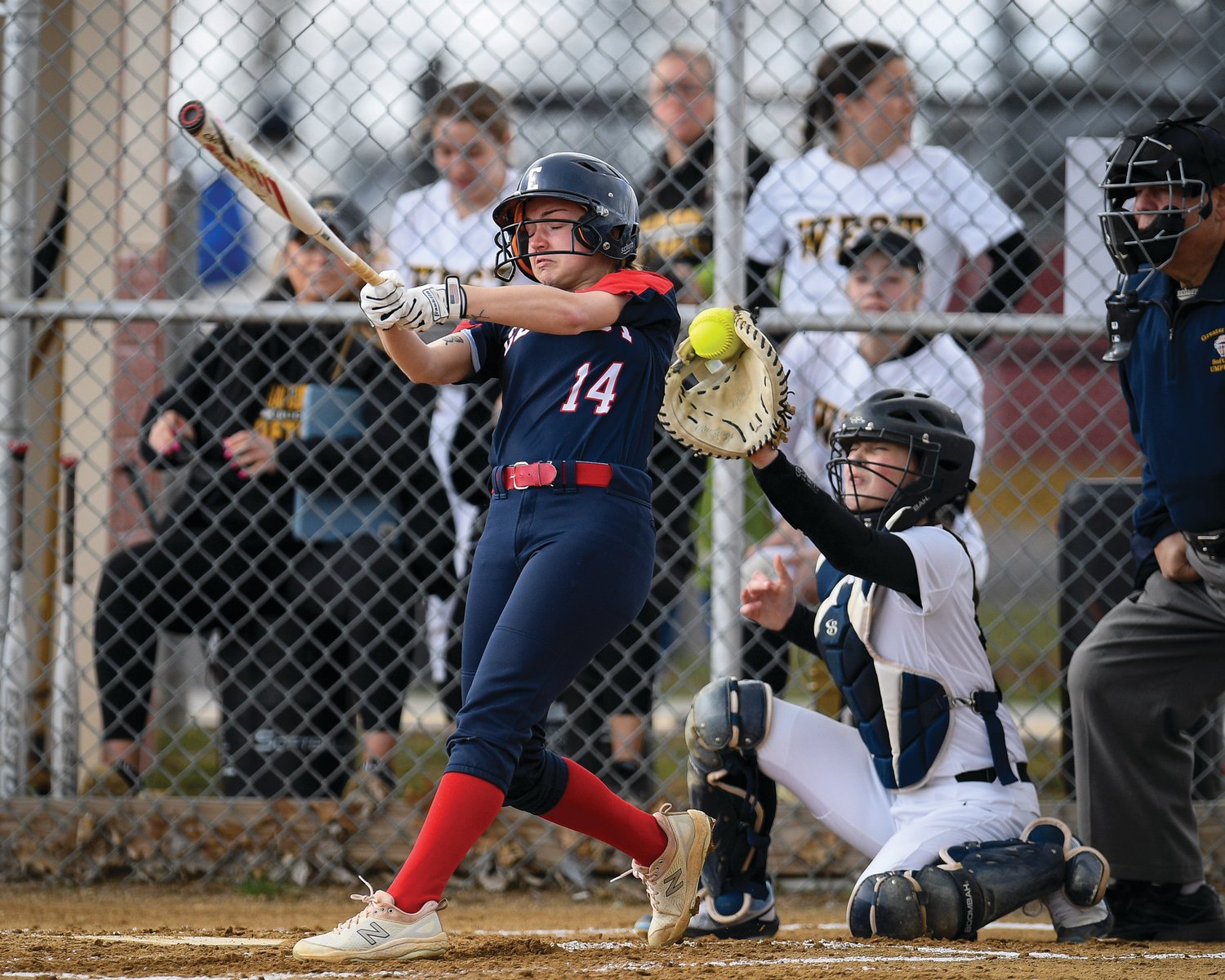 CB East’s Ava Catron can’t catch up to a fastball from CB West pitcher Sienna Lawson.