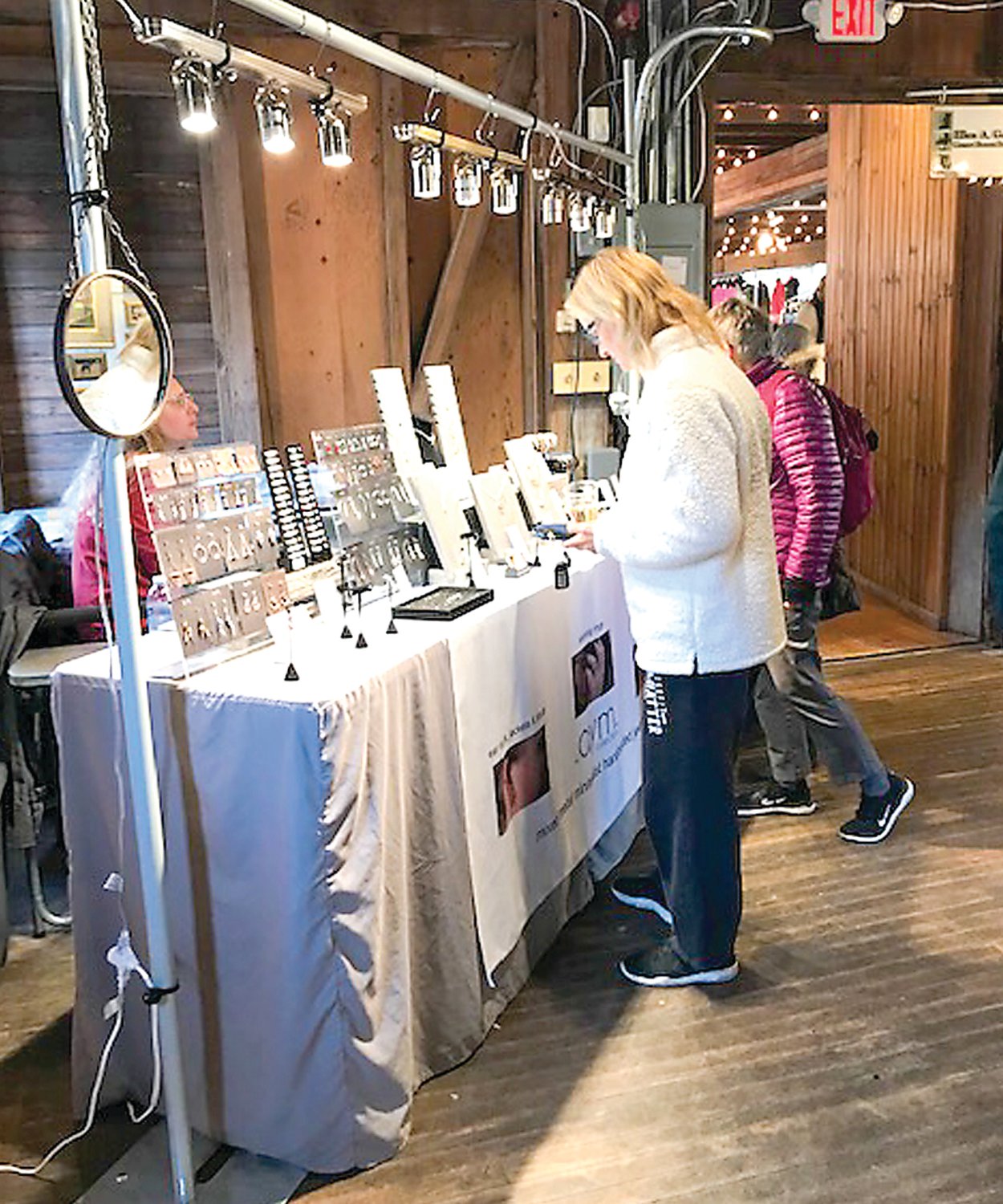 A customer browses jewelry selections at a previous Spring Fine Arts & Crafts Show at Prallsville Mills. The show takes place April 1 and 2 this year.