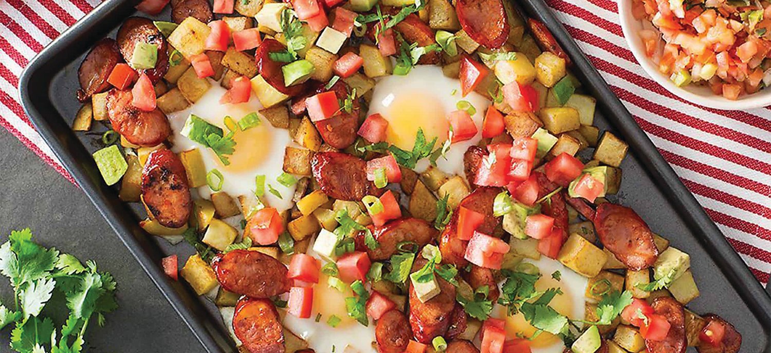 Eggs add color, flavor and nutrition to this sheet pan dinner that comes together quickly. Leave out the sausage and it will work for a vegetarian.