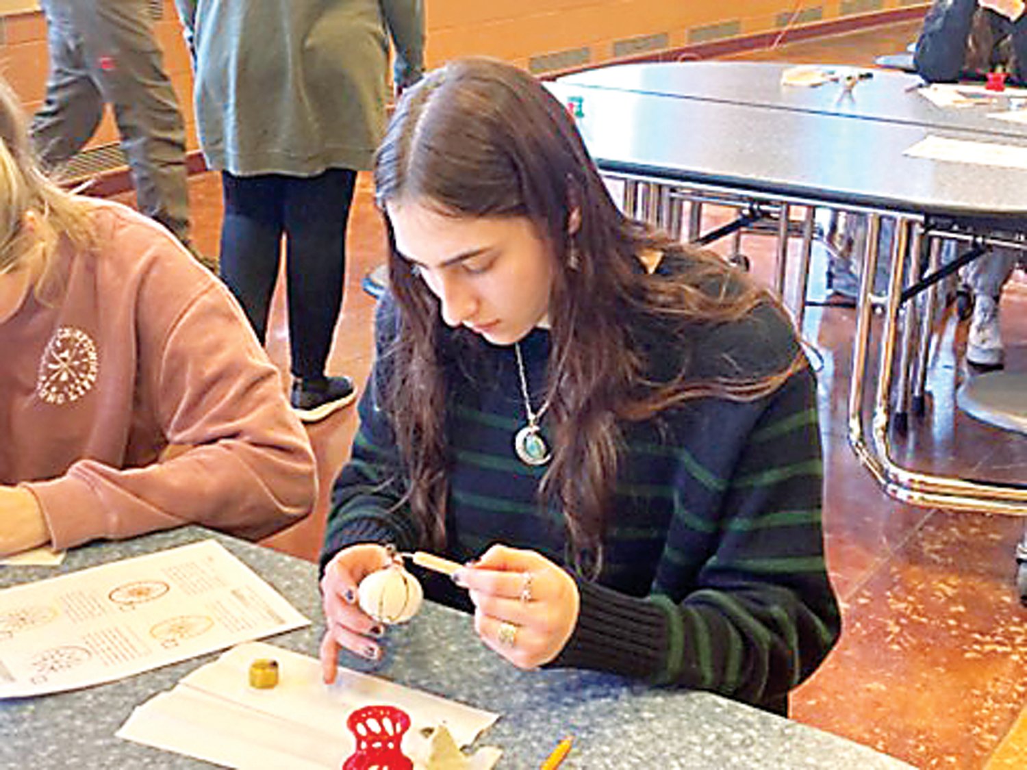 Council Rock South student Maddy Dorf decorates an egg using the Ukranian technique of Pysanky.