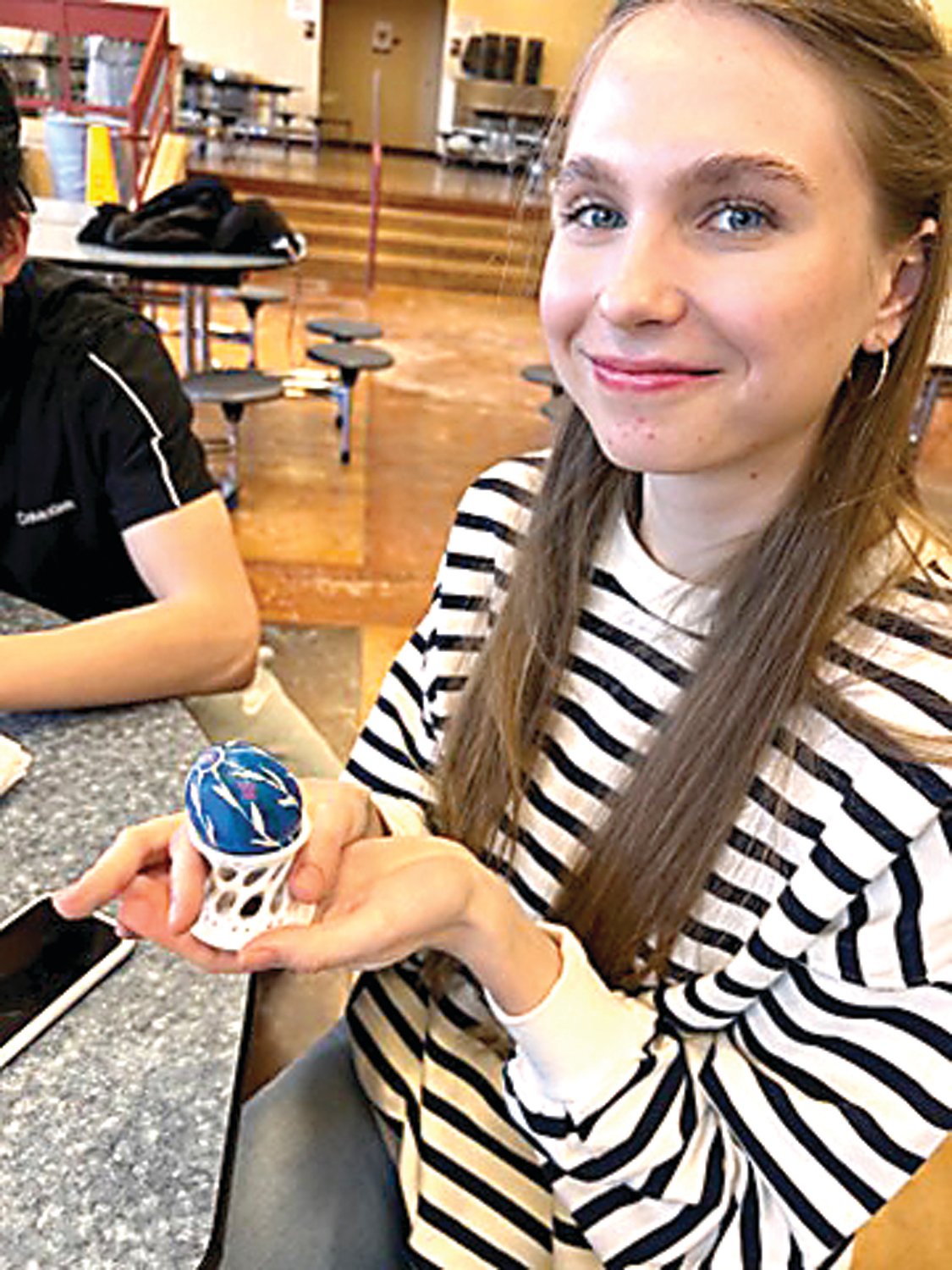 Council Rock South student Daria Kulish shows off her Easter egg decorated using the Ukranian technique of Pysanky.