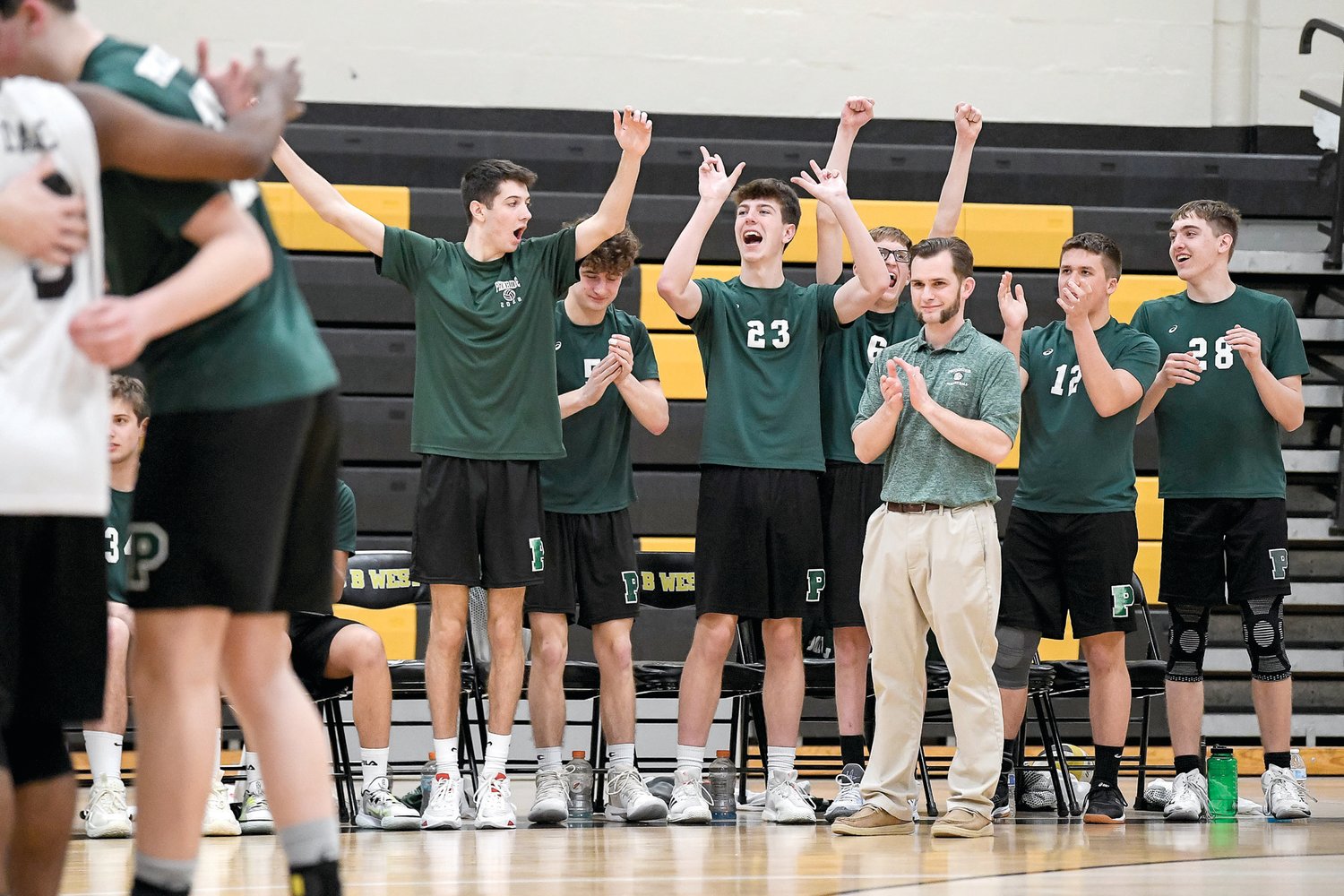 The Pennridge bench of mostly starters reacts to the backups taking the lead late in the third set.
