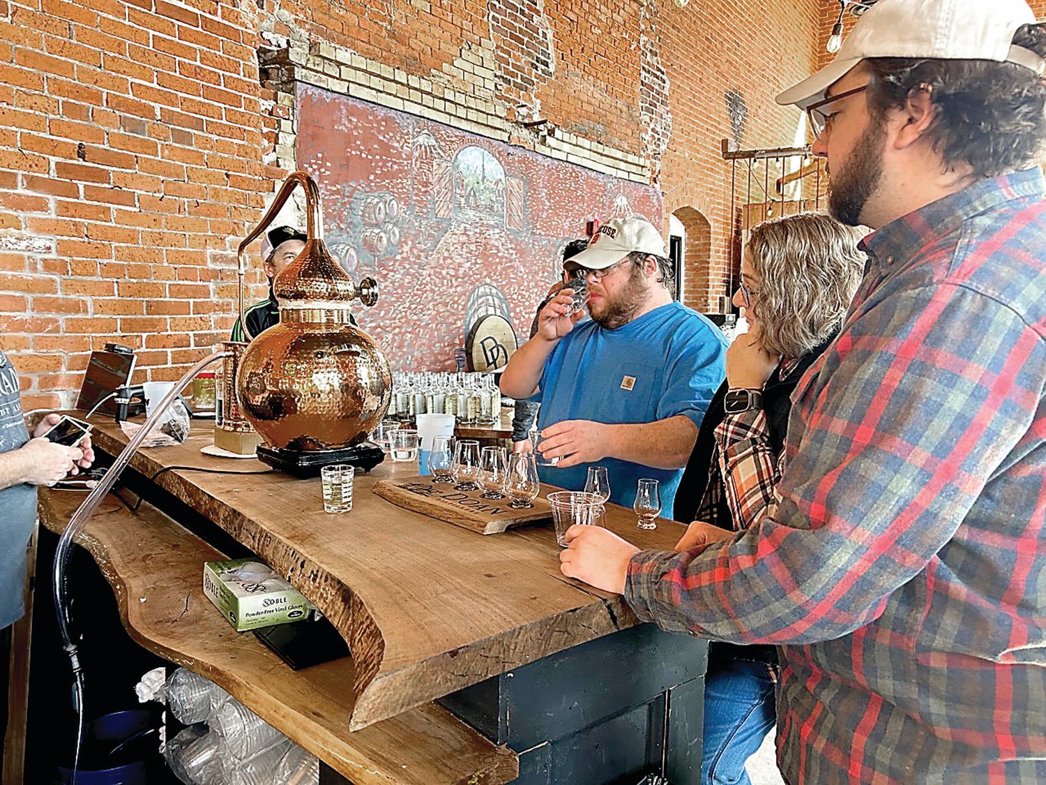 Northampton Community College students taste stills from the limbic system at Doan Distillery.