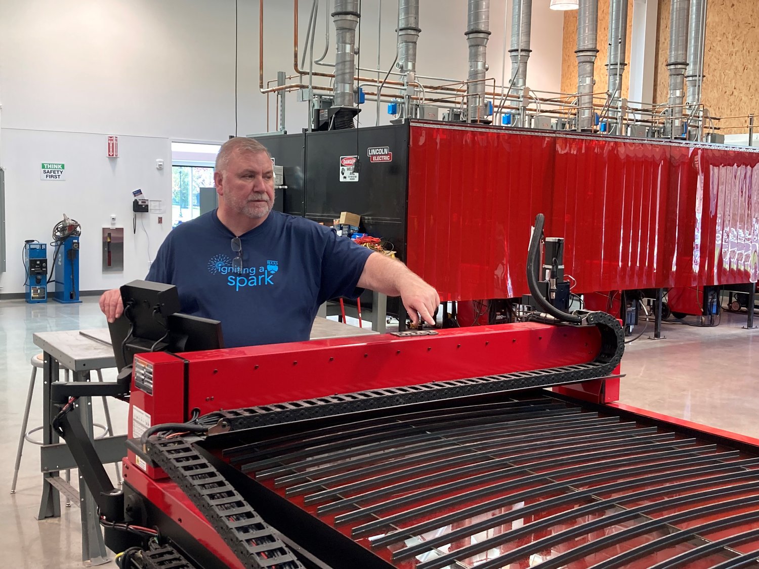 Bucks County Community College instructor Joe Coates shows off a giant plasma table that can produce all kinds of metal shapes at BCCC’s new Center for Advanced Technologies in Bristol Township.