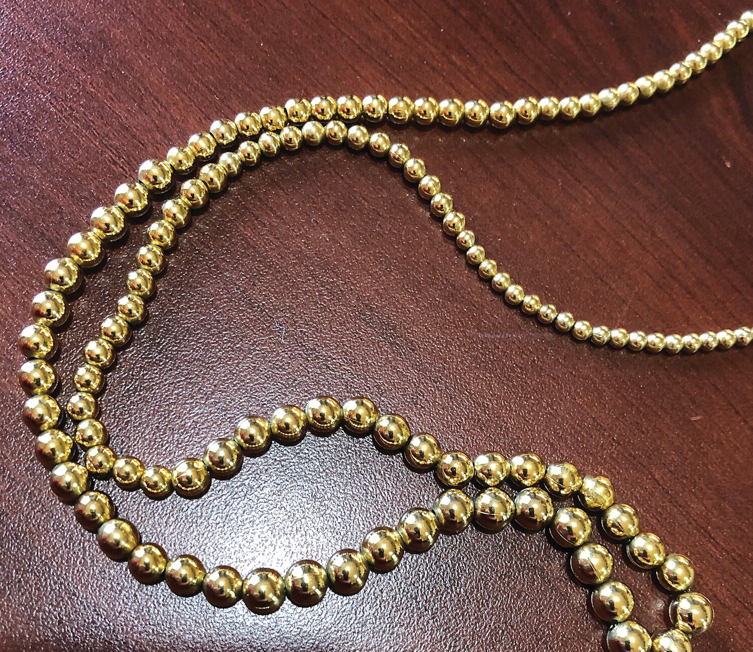 An add-a-bead gold necklace.