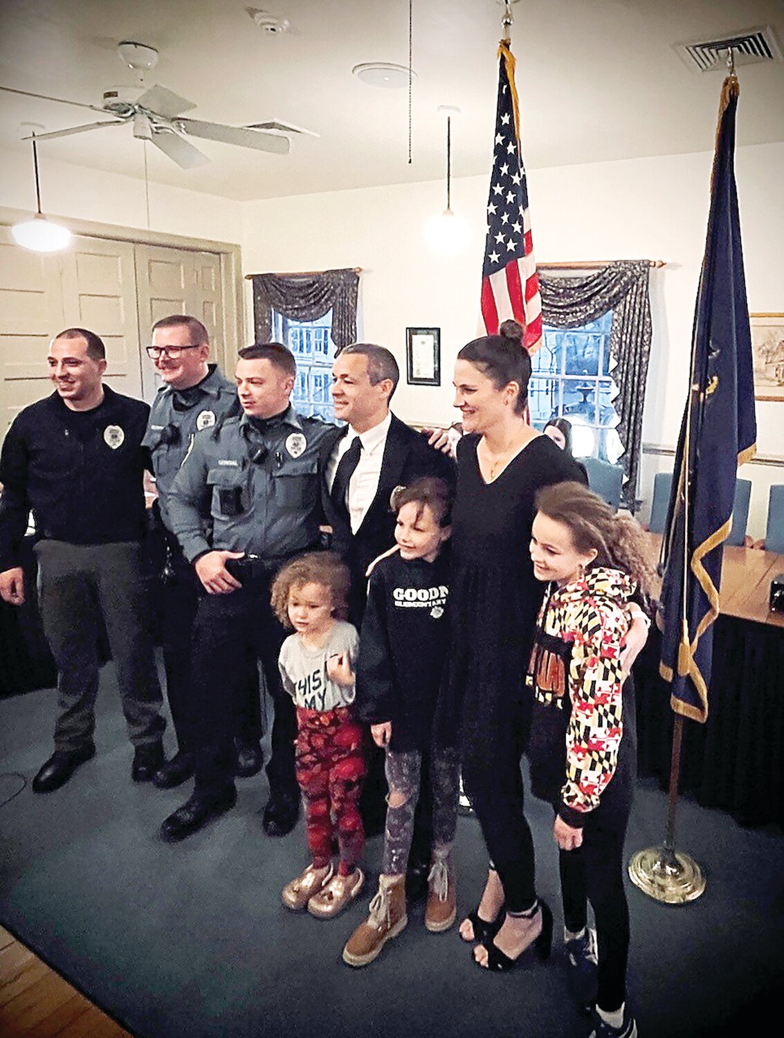 New Yardley Borough part-time Police Officer James Routh (in suit, fourth from left) is joined by his wife, children and some fellow officers at the April 4 borough council meeting.