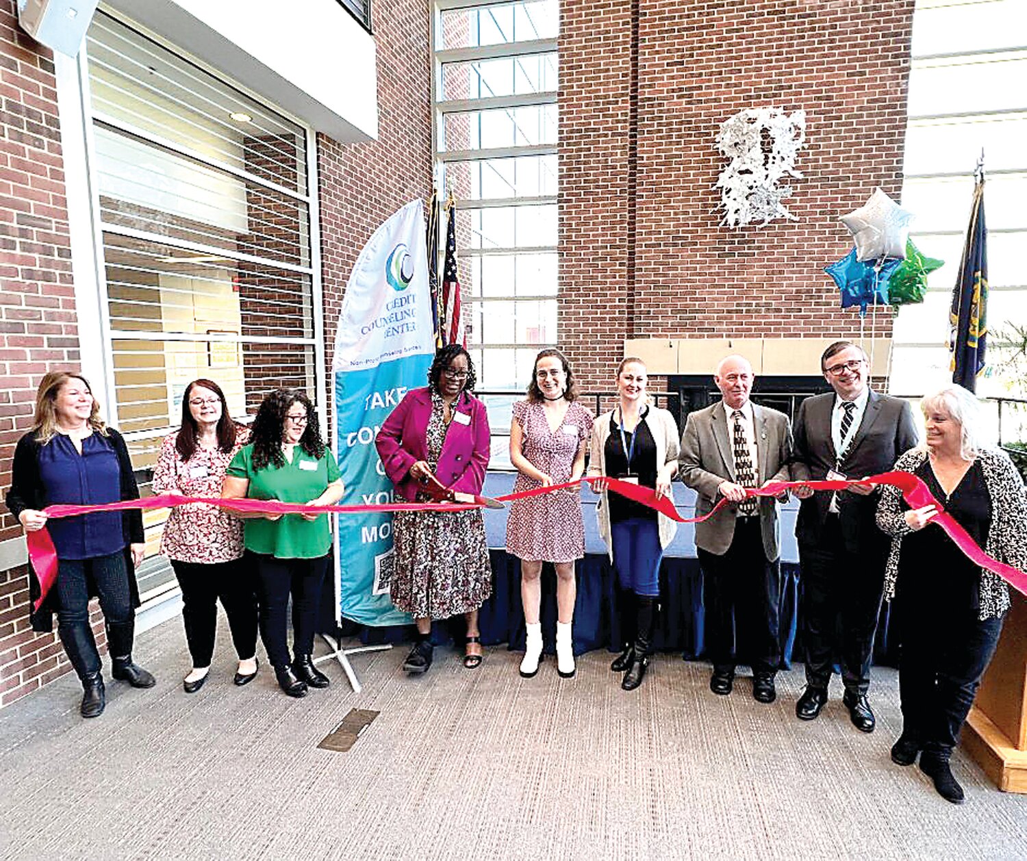 From left: Paula Powers-Watts, executive director of Credit Counseling Center cuts the official red ribbon in celebration of CCC’s new office at the Epstein Campus at Lower Bucks - Bucks County Community College, with Rep. Tina Davis, Jennifer Doyle, Rosa Reyes Santiago, Paula Powers-Watts, Jamie Lehman, Laura Jones-Morales, James Sell (Executive Dean, BCCC), Jody Seutter (AVP Academic Affairs, BCCC), Rose Cooper (Director, Epstein Campus).