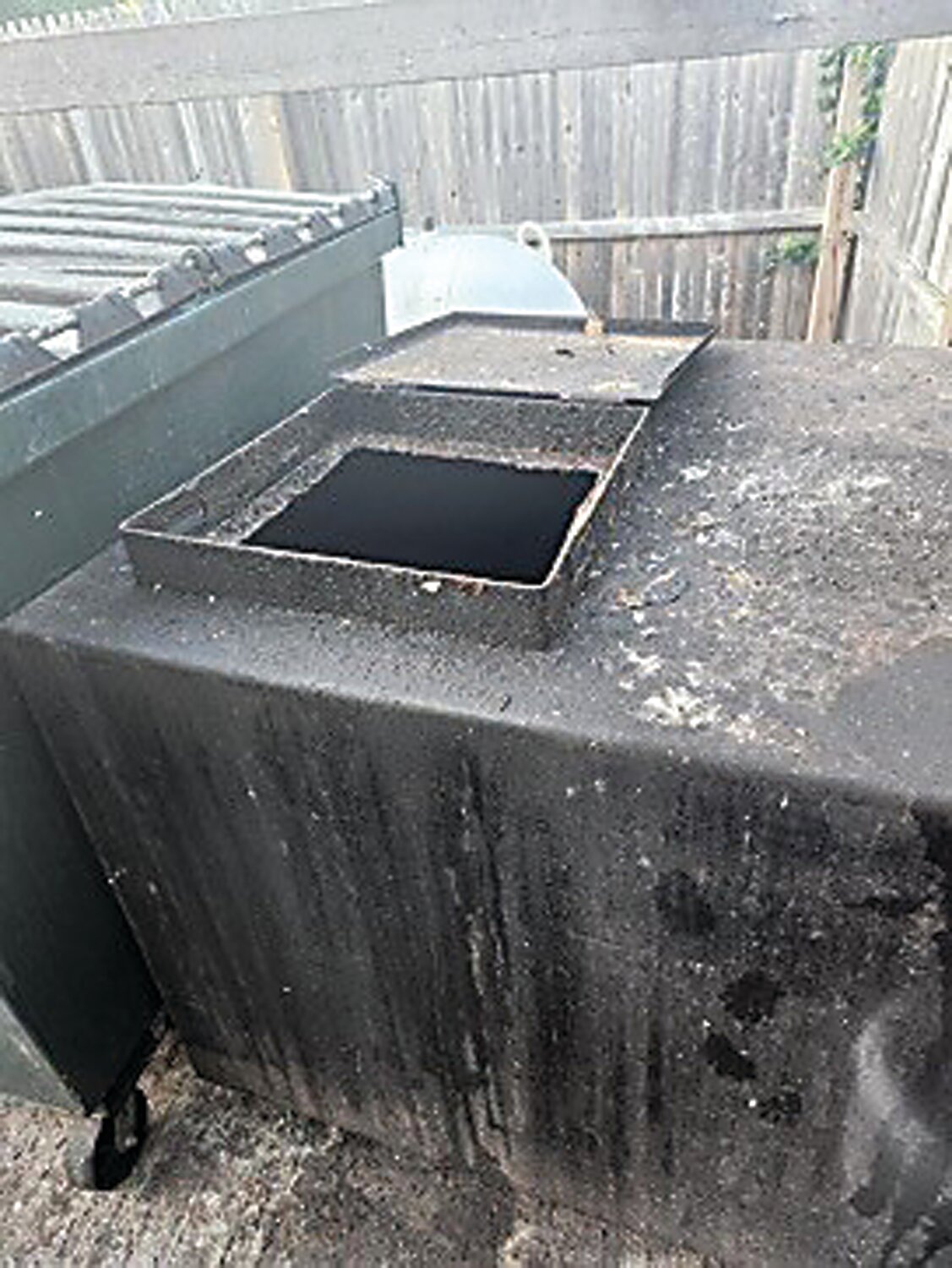 A damaged oil vat sits open after the used cooking oil was siphoned out by thieves.
