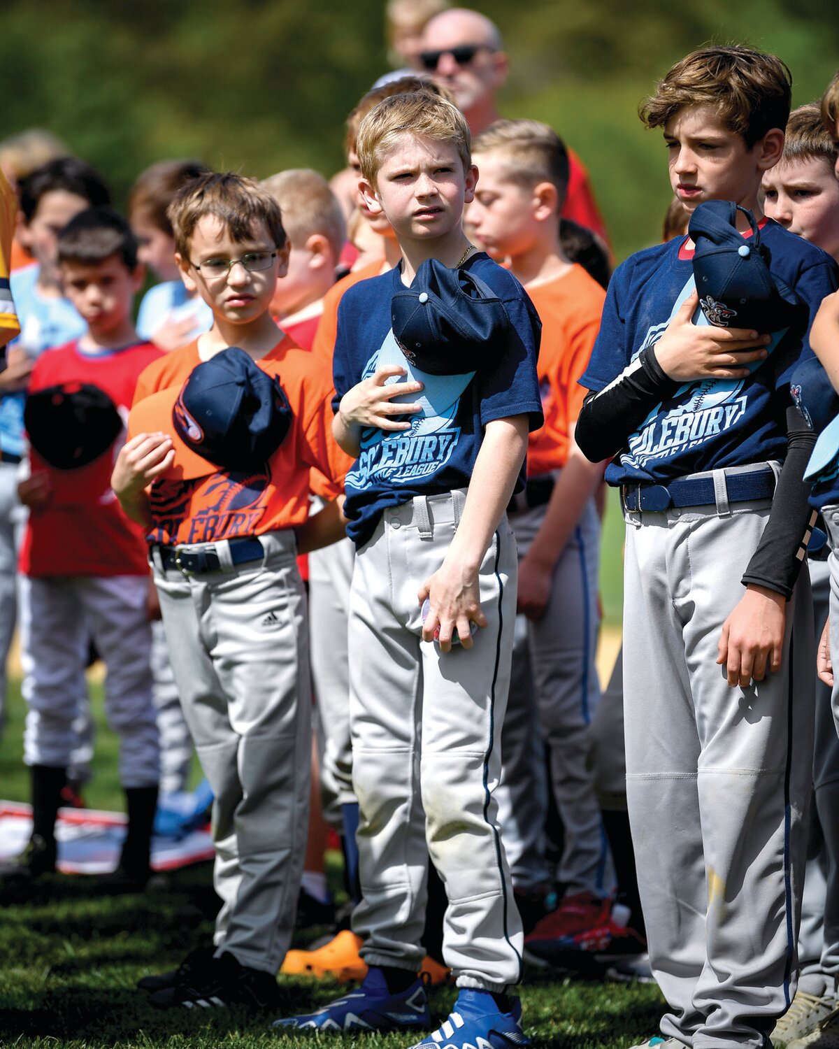 The 10U baseball teams during the national anthem.
