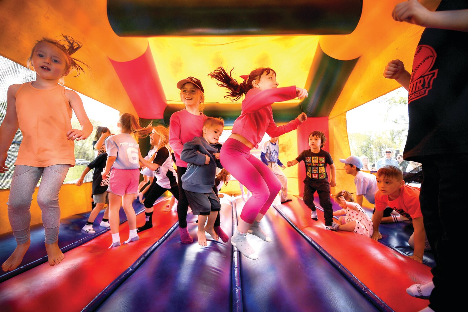 Children play inside the bounce house.
