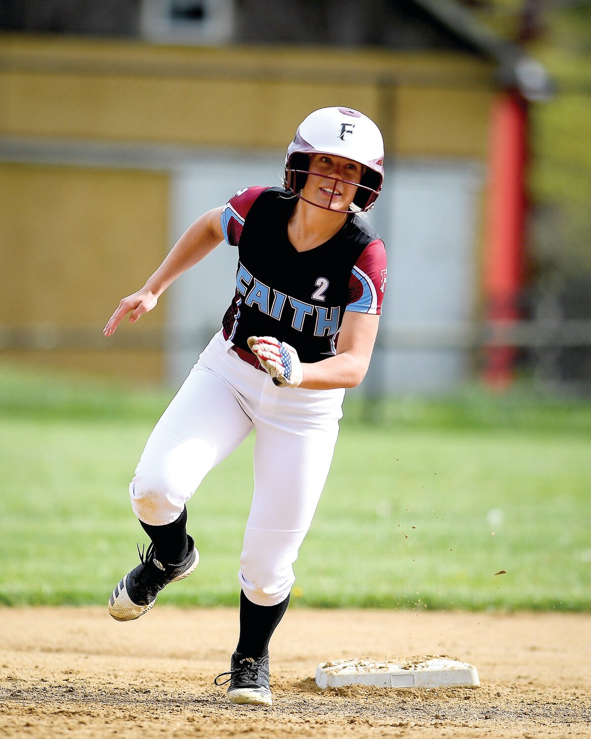 Faith Christian’s Maddee Huber rounds second base going from first to third during the second inning.