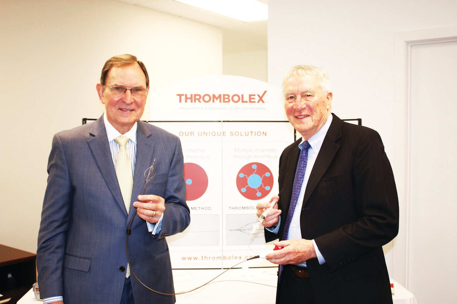 Dr. Brian G. Firth, chief scientific officer, left, and Marvin Woodall, executive chairman of the board of directors, discuss one of Thrombolex’s BASHIR catheters.