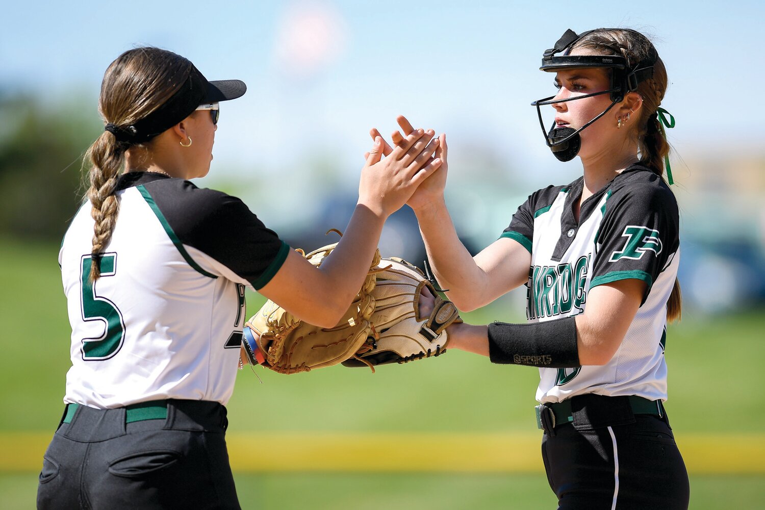 Pennridge third baseman Ryleigh Lilly high-fives pitcher Grace Helbling after one of her 19 strikeouts during Monday’s 7-1 victory over Villa Joseph Marie.