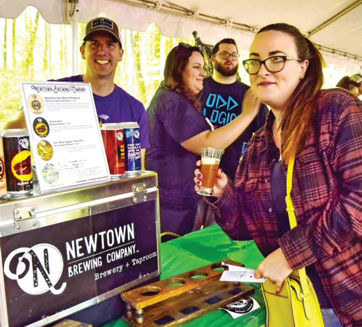 Sinead Rementer is served at the Newtown Brewing Company station by Gregg Bonstein.