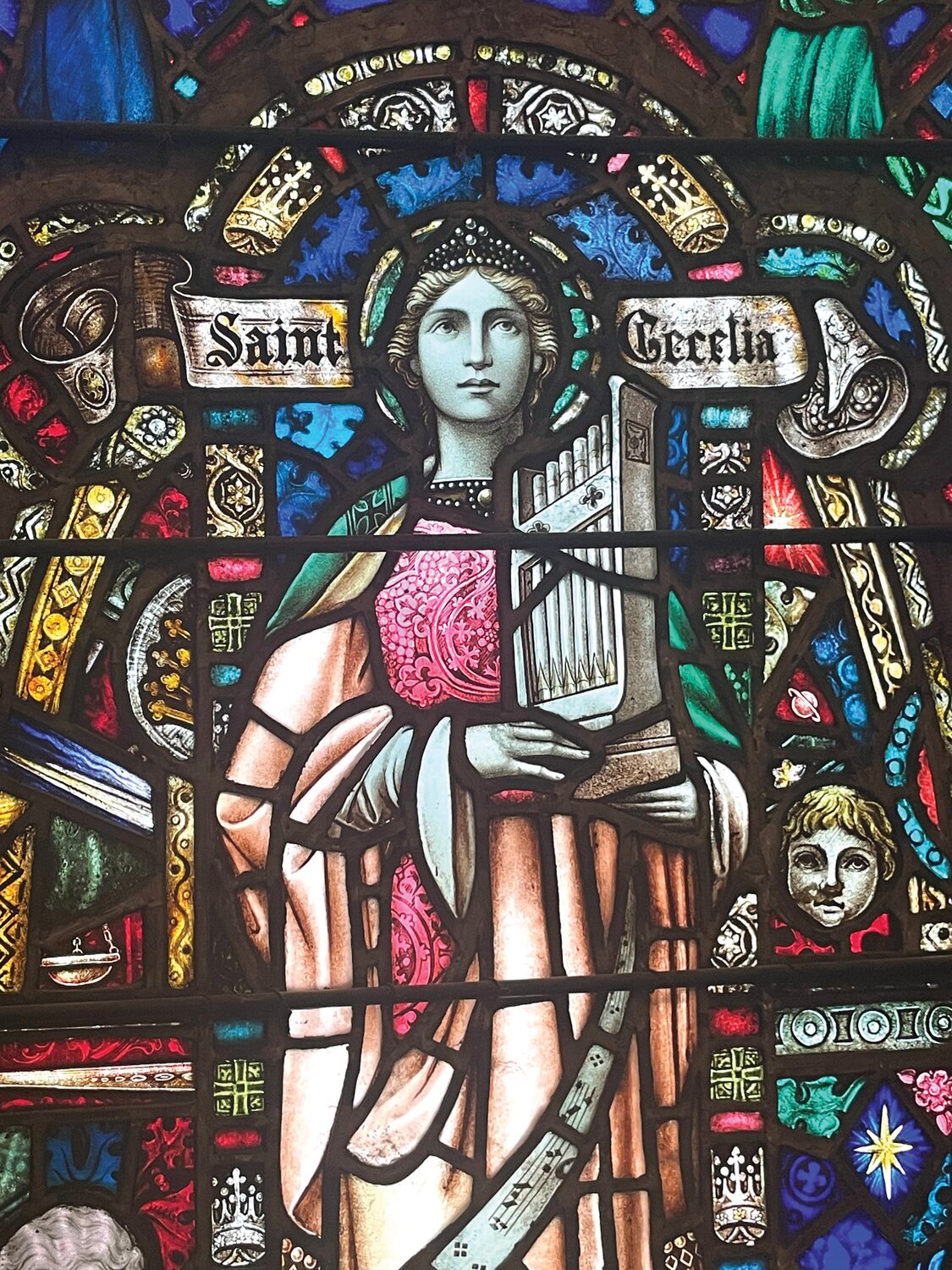 The Saint Cecelia window, made by the Willet Stained Glass and Decorating Co. in Philadelphia, was dedicated in memory of Martha James Lorah in 1922.