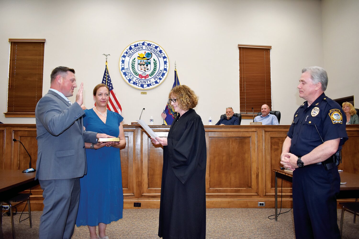 New Hilltown Township Police Officer Ryan Thomas is sworn in by District Judge Regina Armitage. Miller’s wife, Myra, holds the Bible as    police Chief Christopher Engelhart looks on.