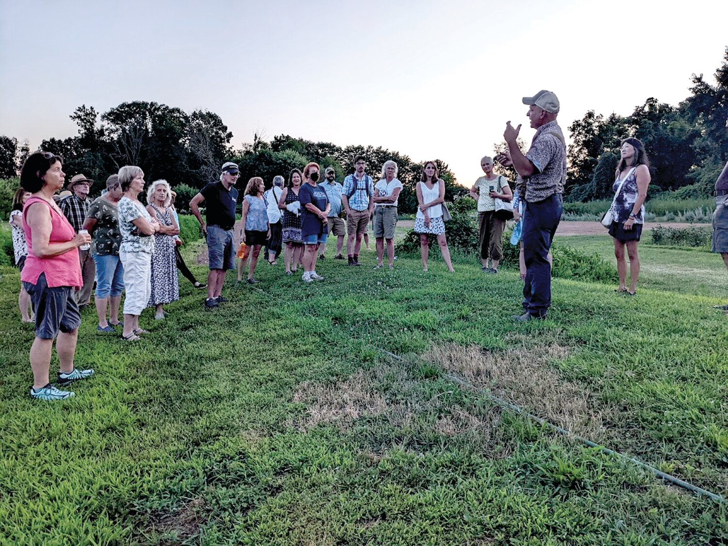 Attendees of a prior year’s farm tour listen to a talk at Bluestem Botanicals.