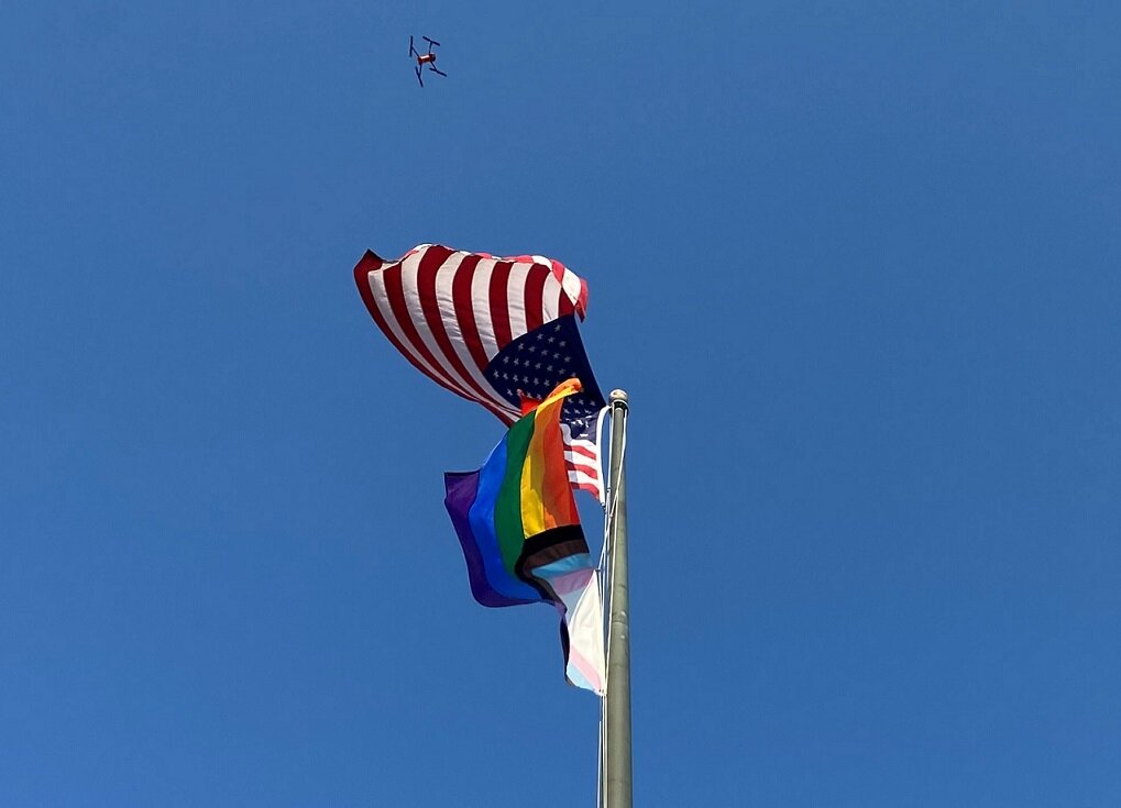 A drone hovers over the Pride flag and the crowd below it Thursday at a ceremony marking the beginning of Pride Month in Doylestown. Members  of Doylestown’s Rainbow Room raised the Pride flag at the Doylestown Administrative Building on East Court Street.