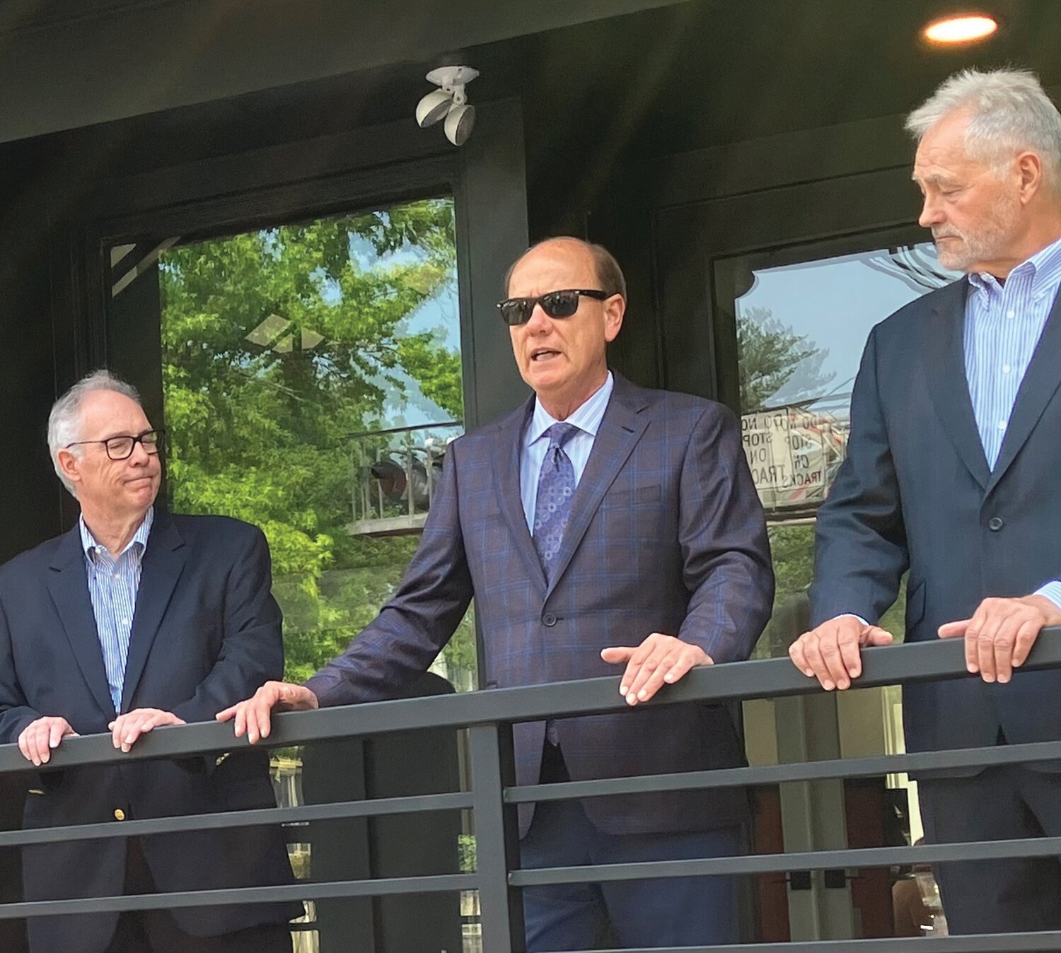 Flanked by Architect Ralph Fey, left, and lead donor Stephen H. Can, right, New Hope Mayor Laurence Keller discusses the reopening of the New Hope Arts Center on Stockton Avenue.