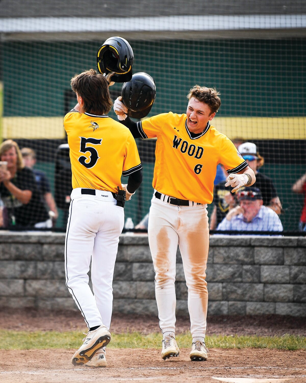 Archbishop Wood’s Braden Kelly is greeted at home after his home run in the third inning by Sean Burke.