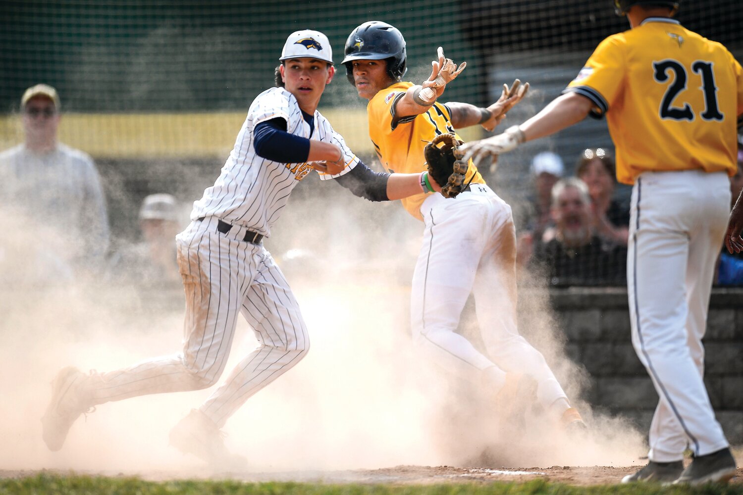 Archbishop Wood’s Dariel Tiburcio signals safe after stealing home on a wild pitch during the nine-run first inning.