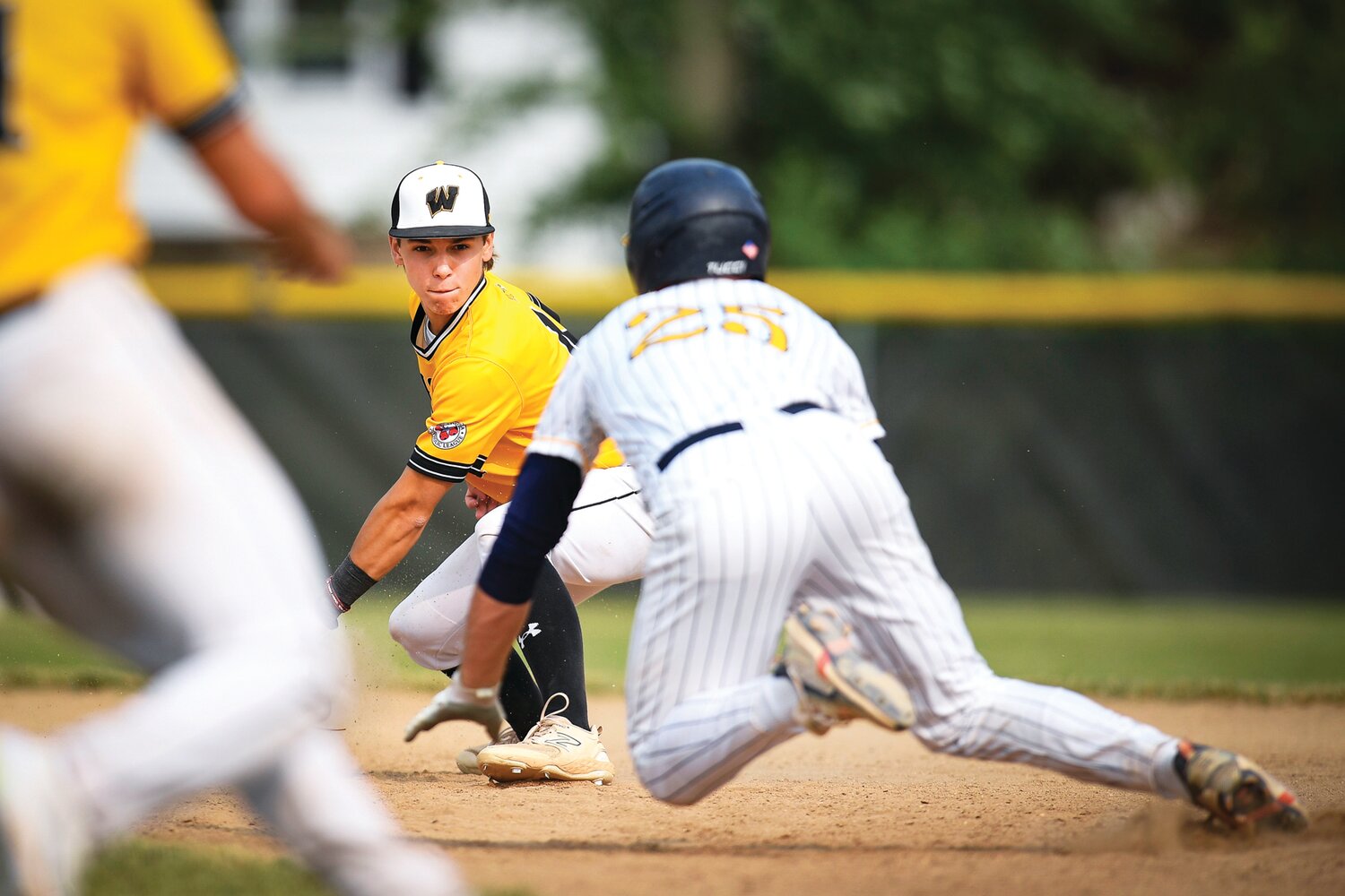 Archbishop Wood second baseman JP DiGuiseppe  fields a throw and tags out Pope John Paul II’s Brendan Kenning after trying to stretch a single into a double in the third inning.