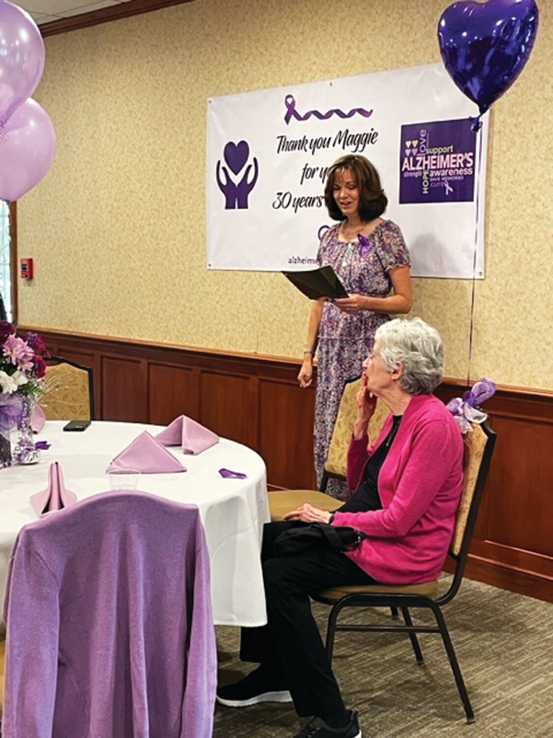 Elizabeth Kauerman speaks during a luncheon honoring Alzheimer's caregiver support group facilitator Maggie Sullivan.