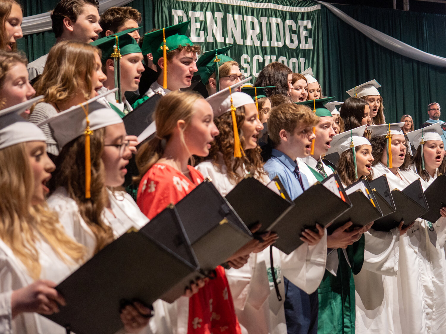 The Pennridge High School choir sings the school's alma mater during Tuesday's graduation ceremony