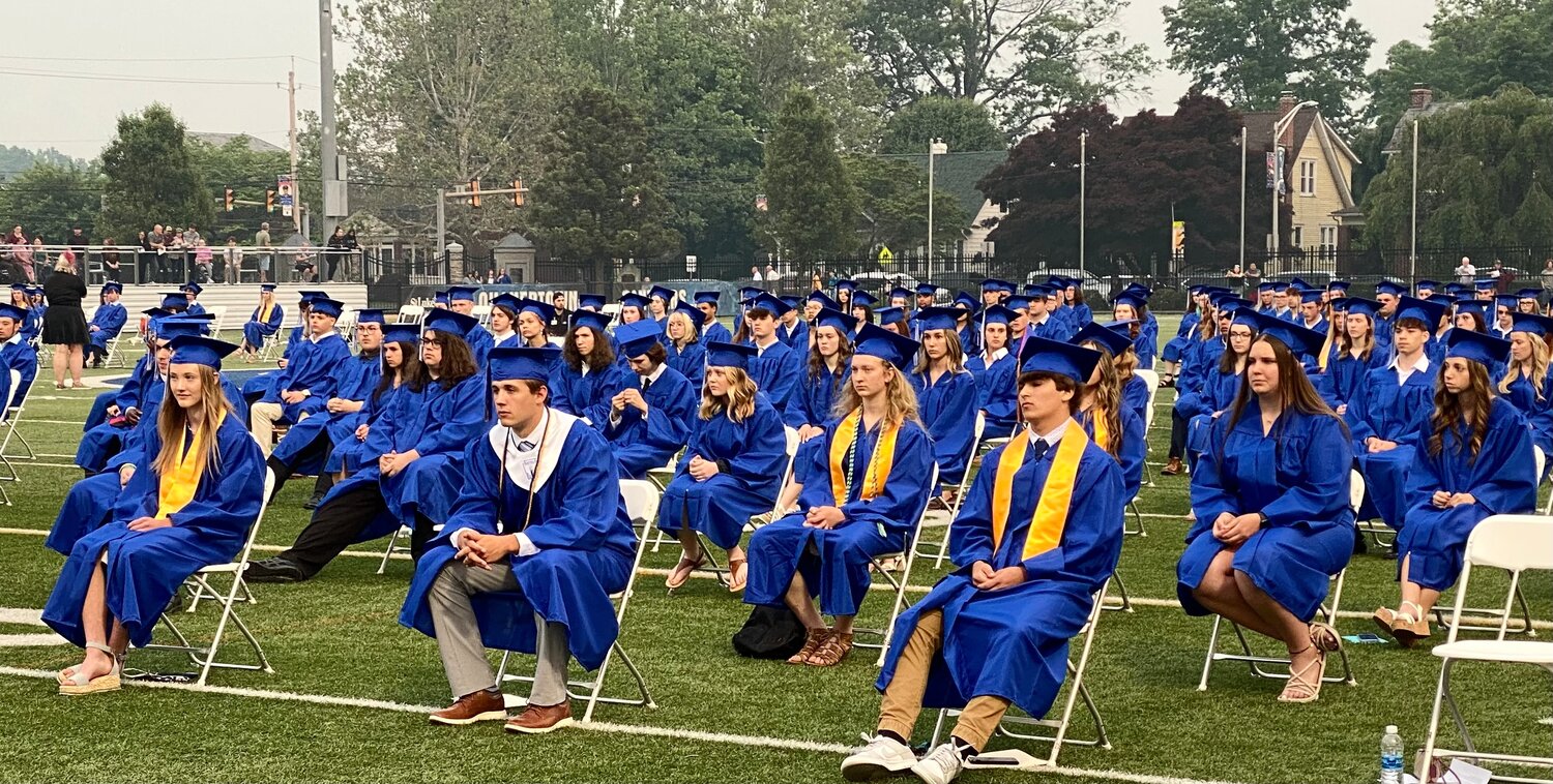 Seated on the football field, the 383 members of the senior class at Quakertown Community High School listens to the ceremony’s speakers.